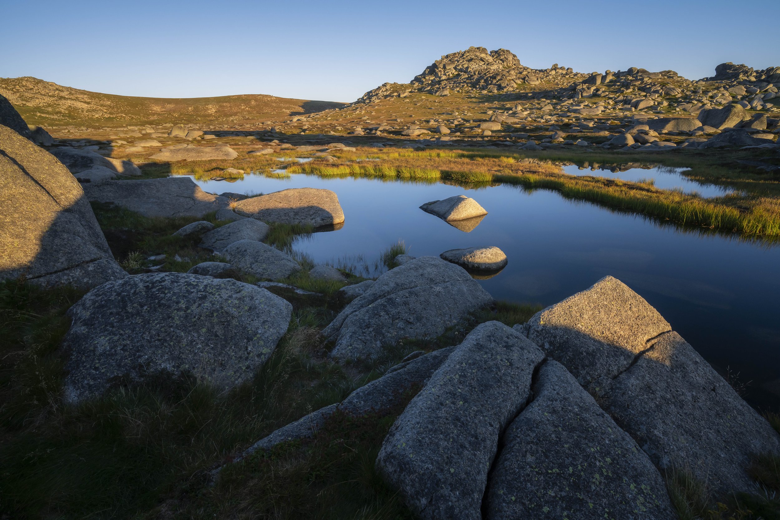 Mount Kosciuszko in Australia at sunrise, showing alpine lakes reflecting the mountains