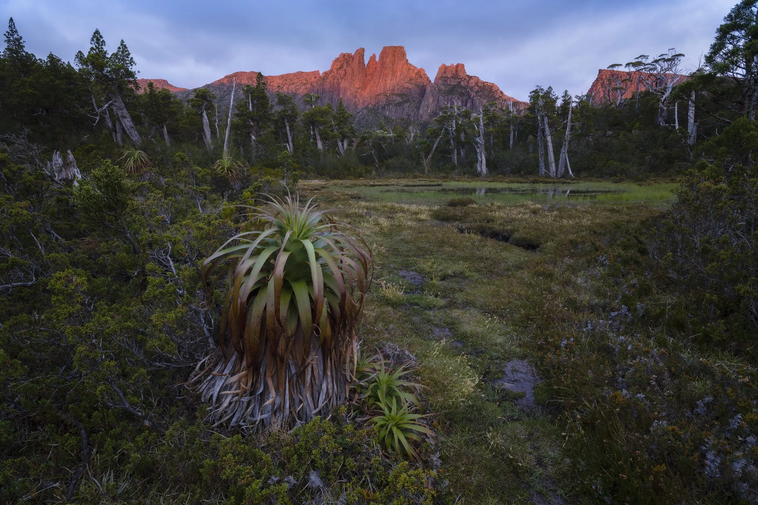 Pool of Memories surrounded by rugged alpine landscape and reflective water