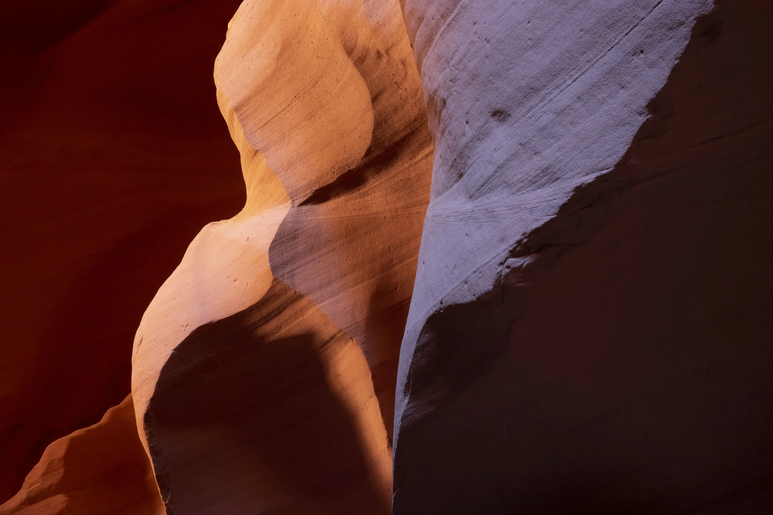 Light casting shadows and highlighting textures on canyon walls