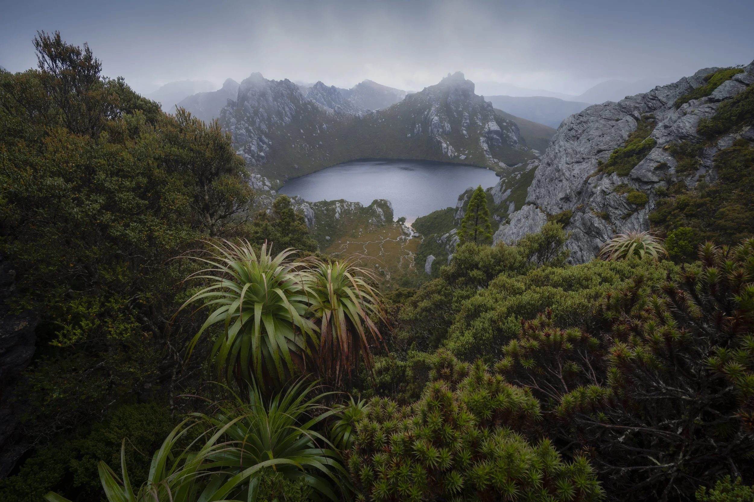 Rain falling over Lake Oberon, with mist and clouds surrounding the alpine landscape