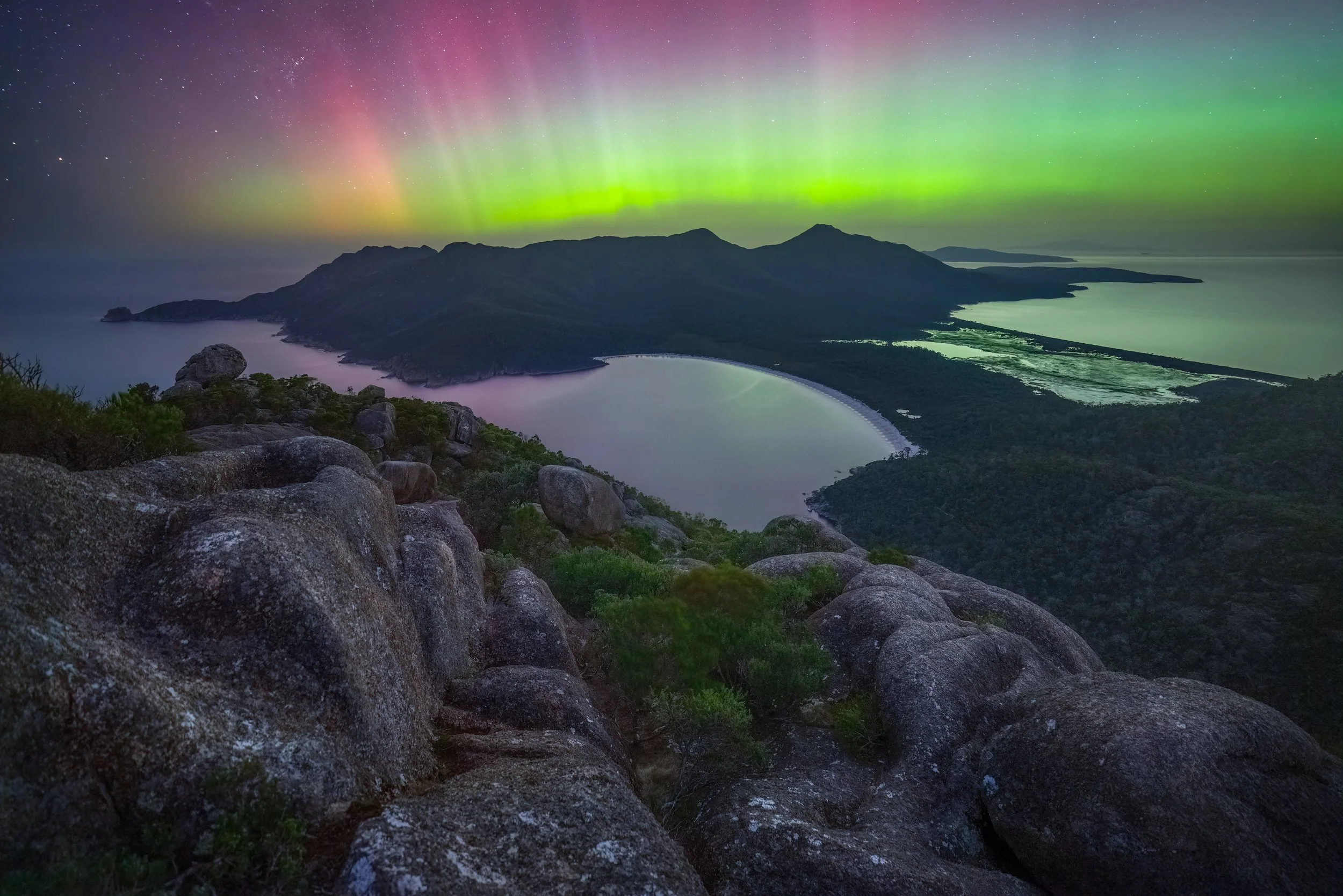Southern lights from Mount Amos under a night sky in Tasmania