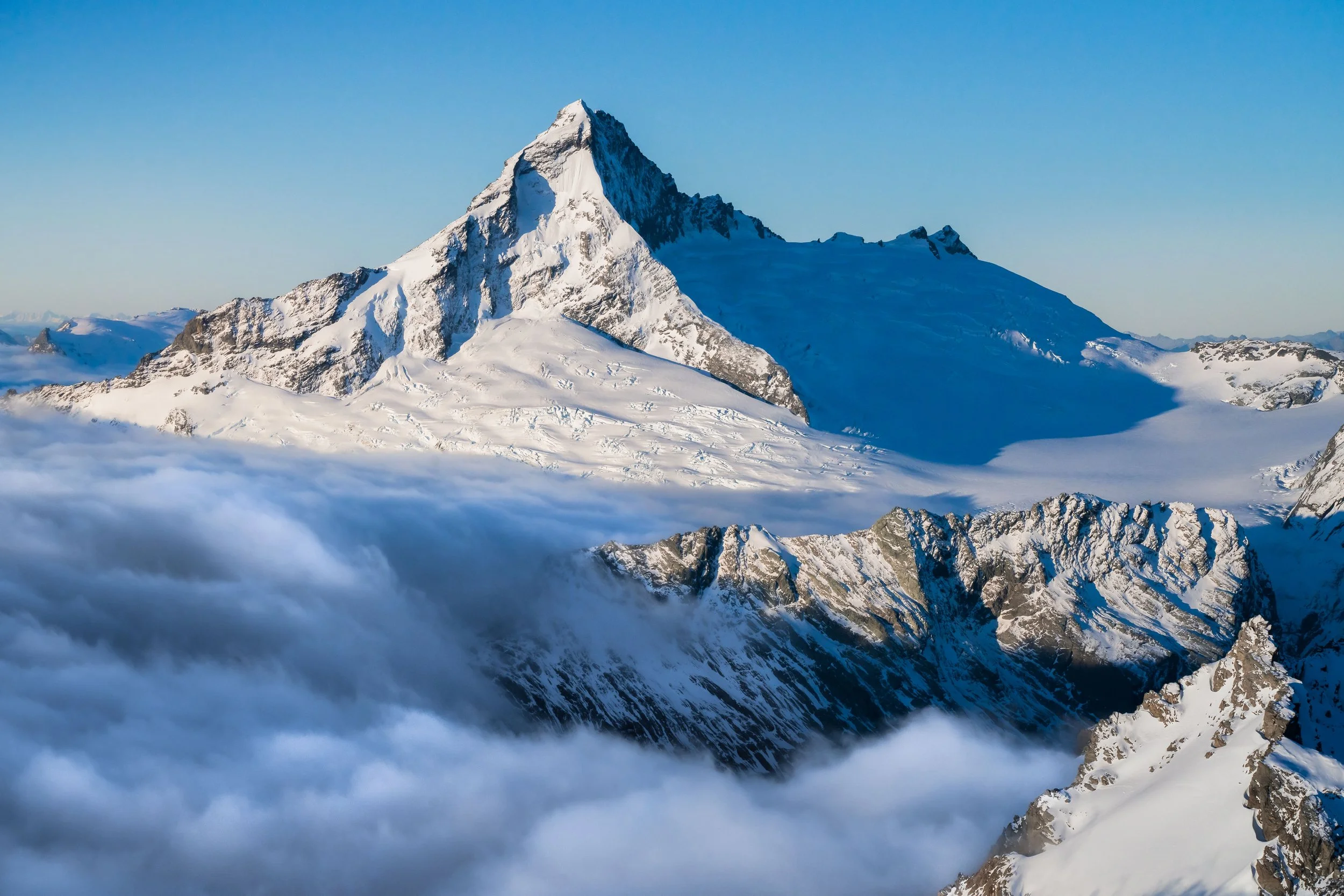 Mount Aspiring rising above alpine valleys with rugged peaks and snow-capped slopes