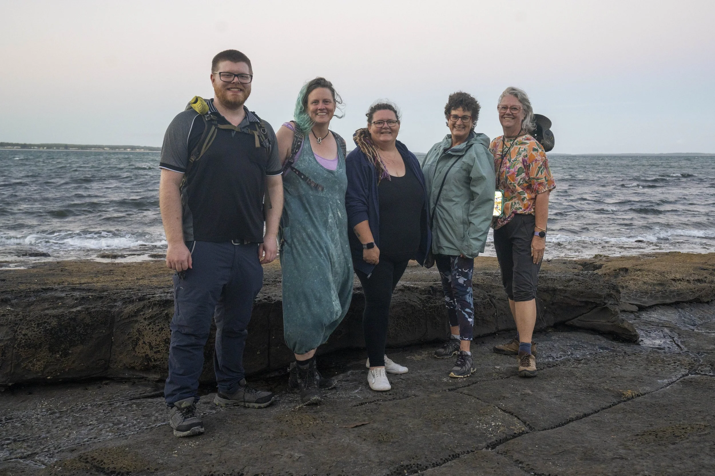 Photography workshop participants posing together after an outdoor session