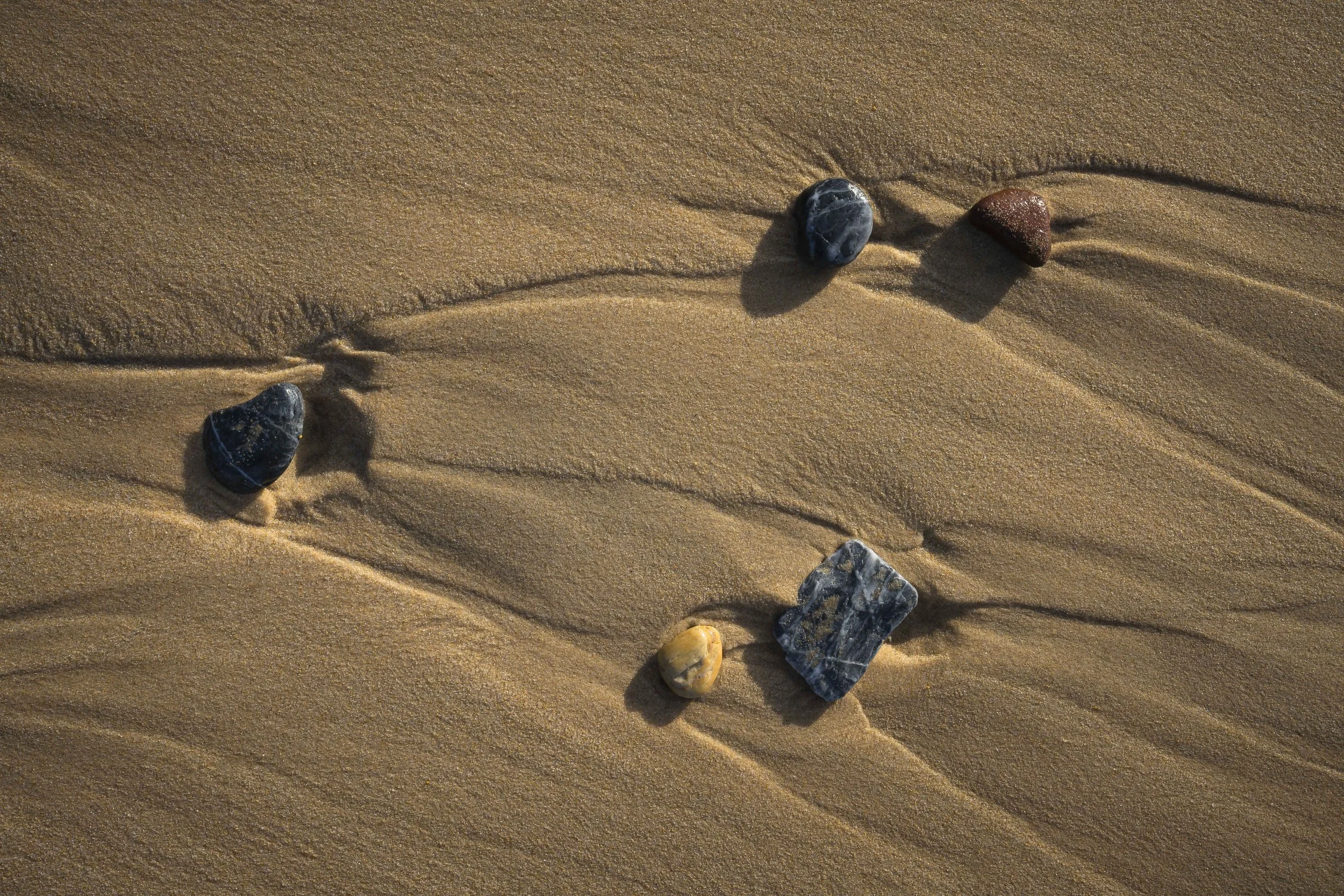 Detailed view of rocks and sand texture along the shoreline