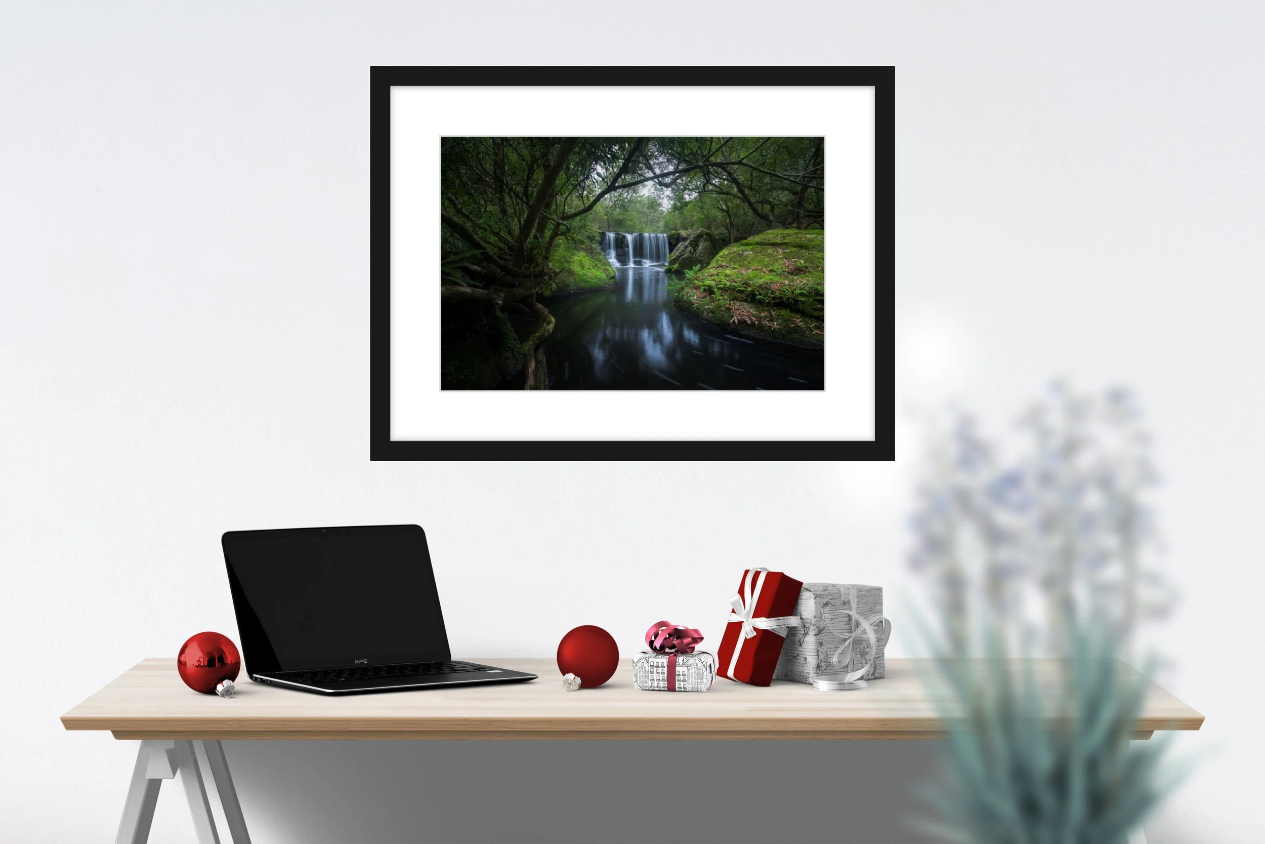 Framed landscape photo by Samuel Markham hanging above a desk
