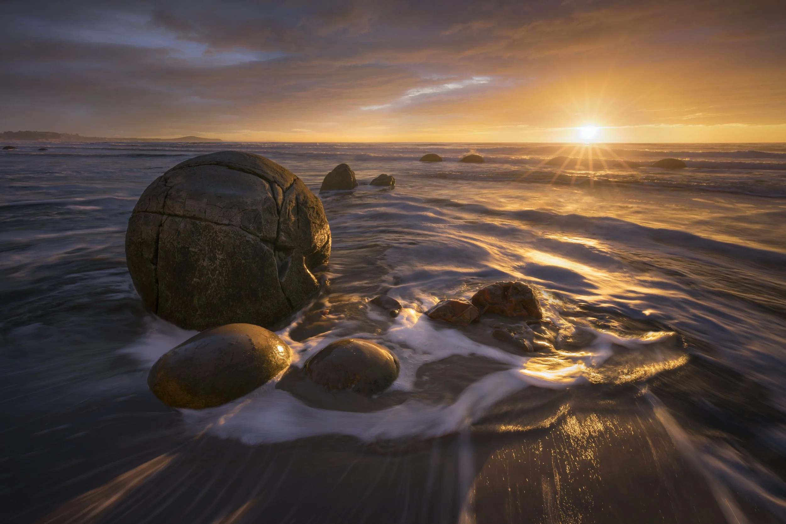 Moeraki Boulders on the beach illuminated by early morning light, New Zealand