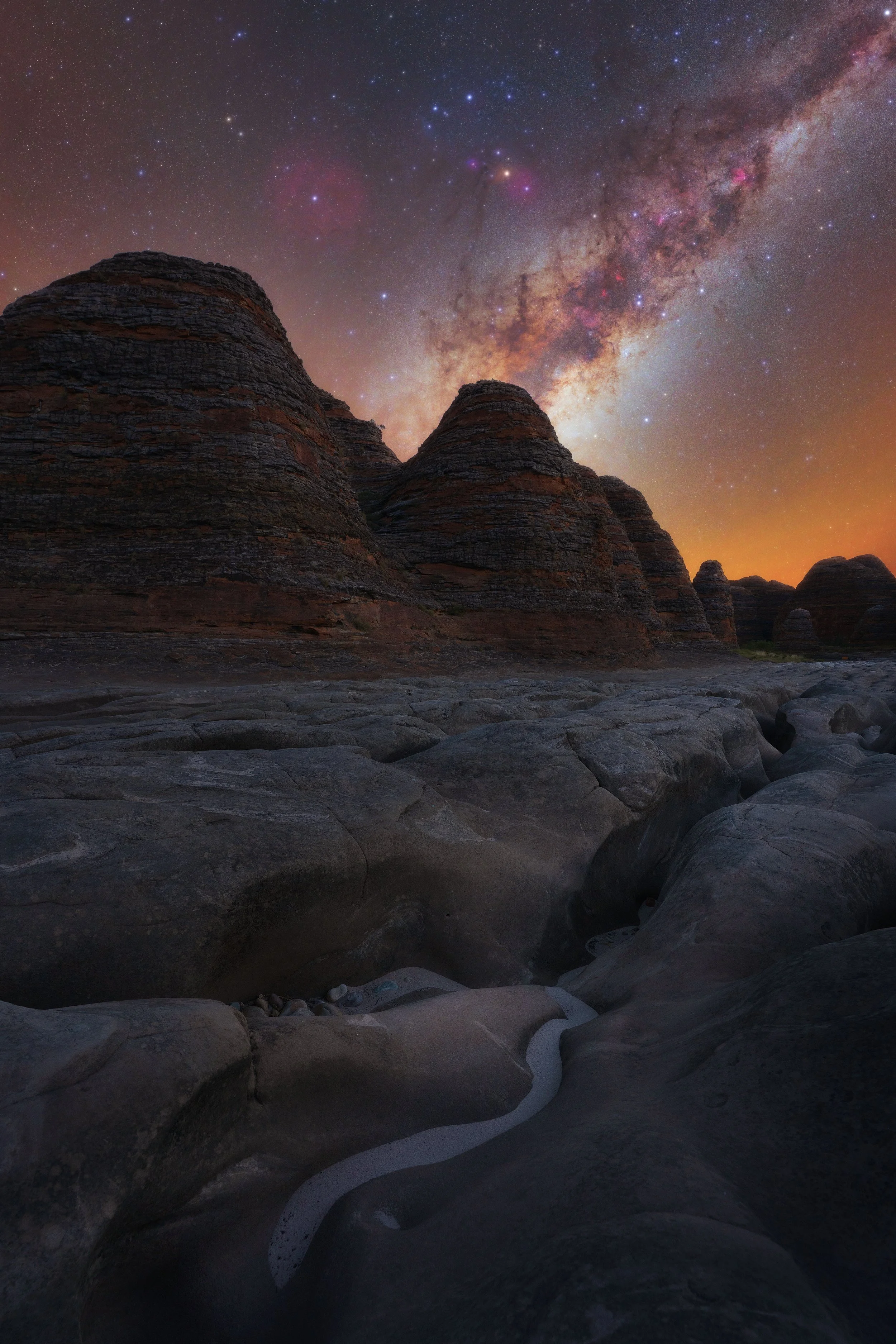 Milky Way rising above the striped sandstone domes of the Bungle Bungle Range in the Kimberley, Western Australia.