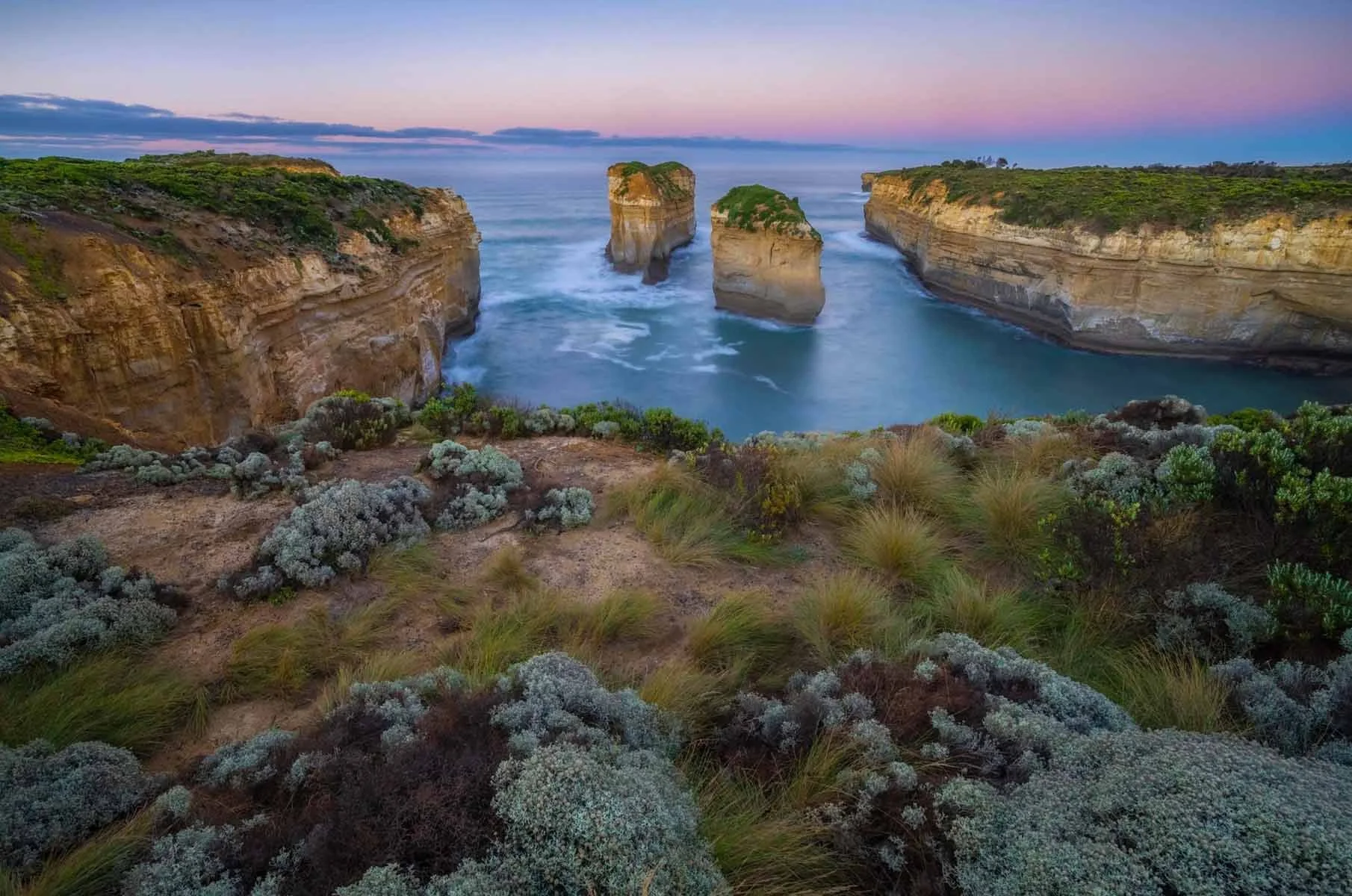 Sunrise over Tom and Eve with soft pastel colours in the sky