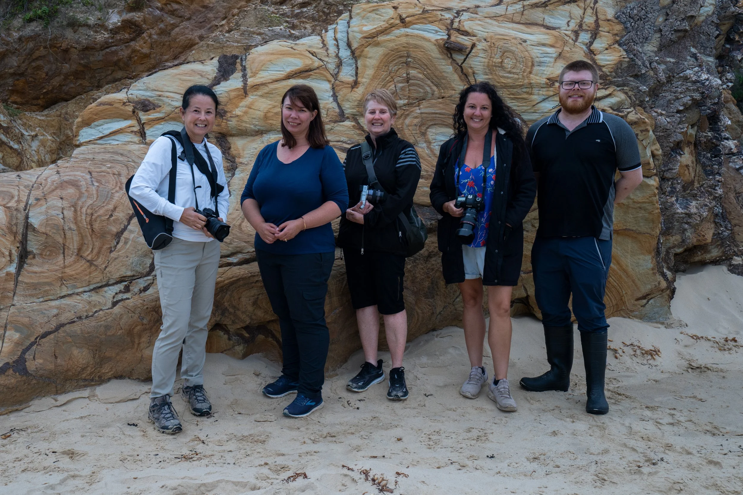 Photography workshop participants posing together after an outdoor session