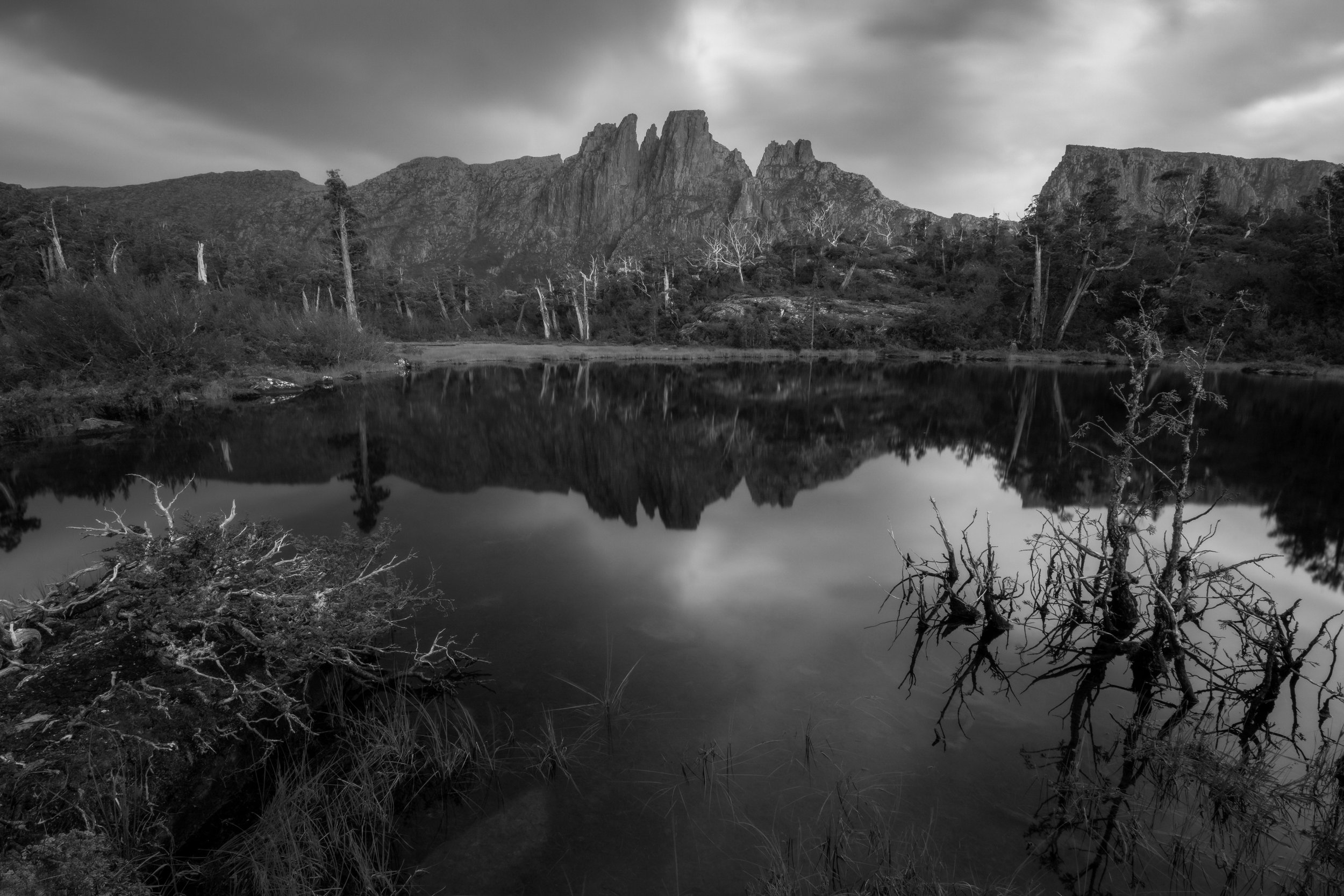 Monochrome photograph of Pool of Memories in Tasmania, Australia, showing reflective waters, forested edges, and tranquil wilderness scenery