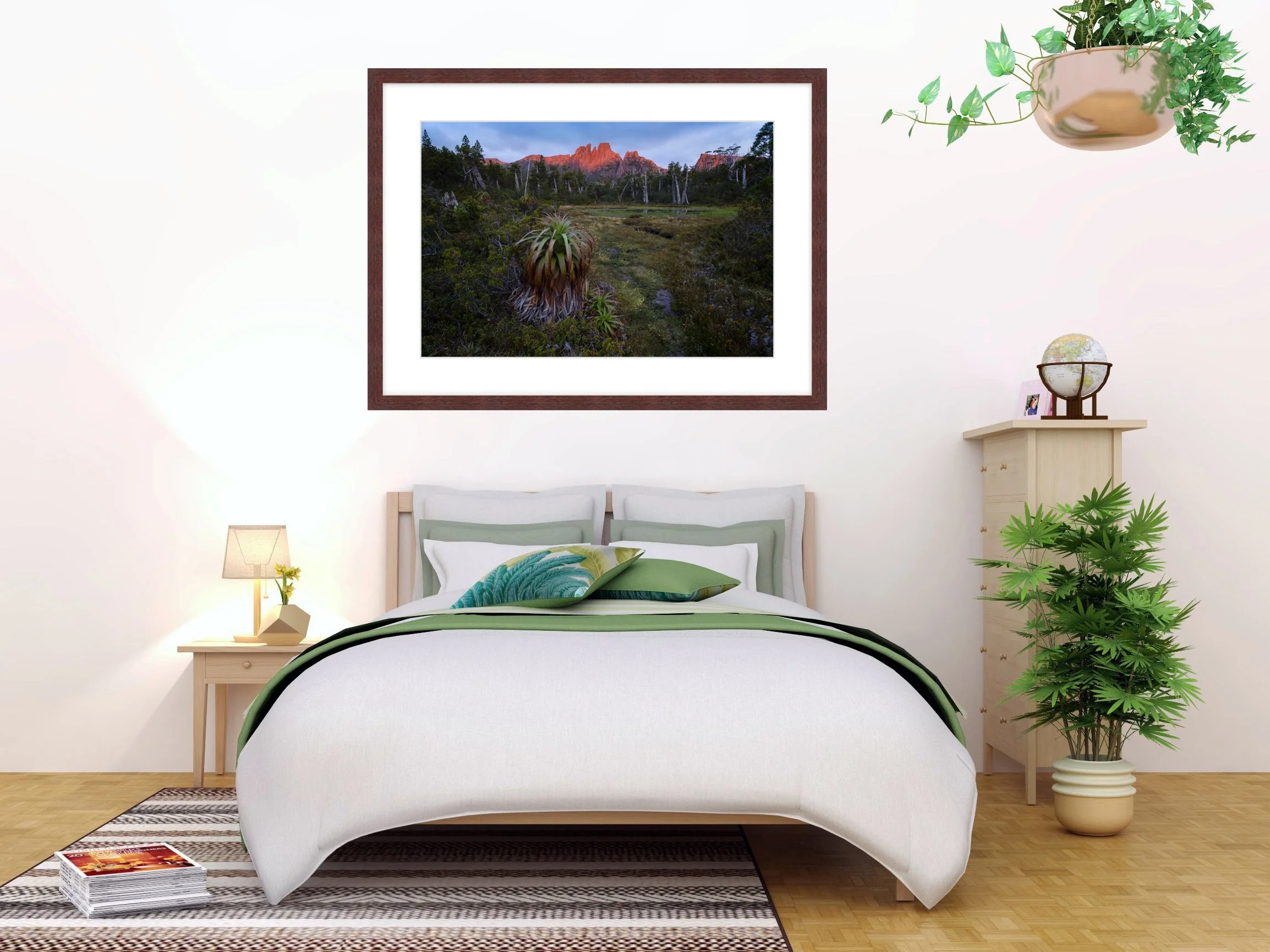 Framed landscape photo by Samuel Markham hanging above a bed
