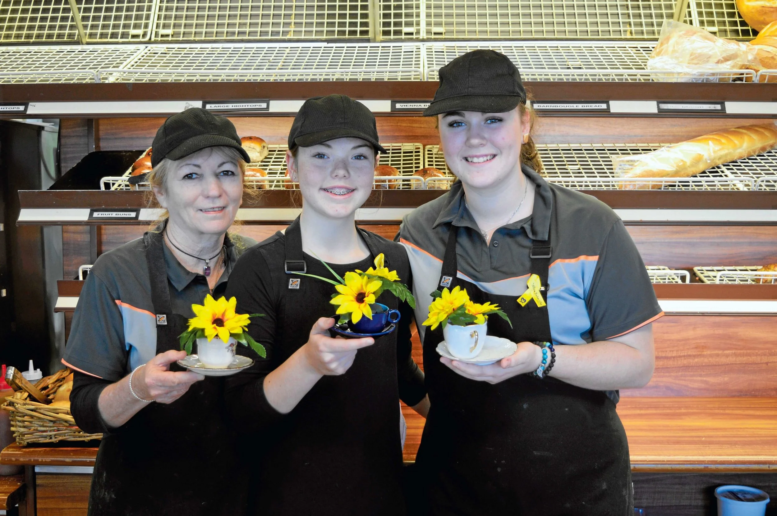 • Cottage Bakery staff Lorraine Carroll, Paige Chorley and Jemaya Hilder spreading kindness to customers.