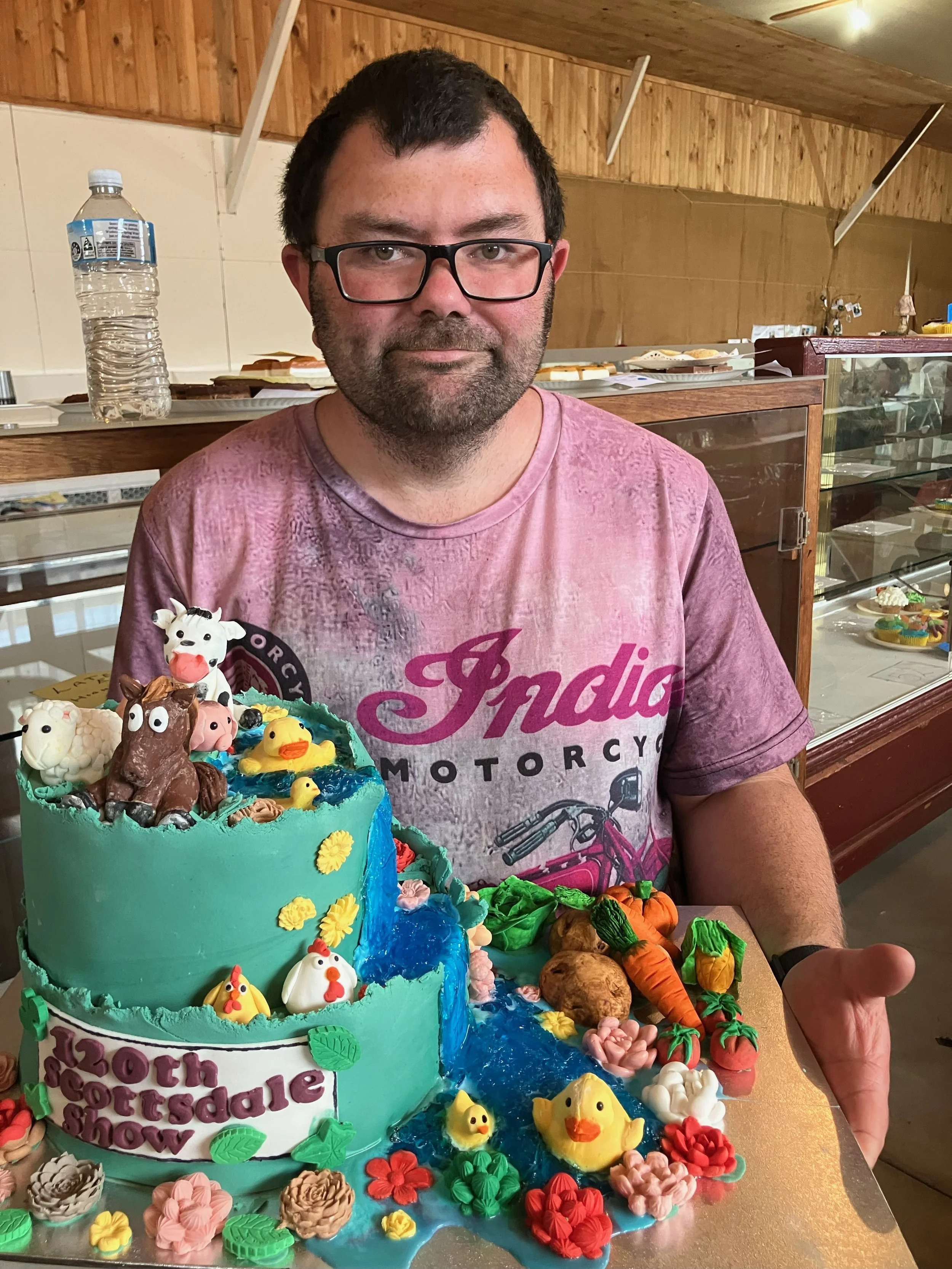 Patrick Denny with a cake creationn for the Scottsdale Show.jpeg