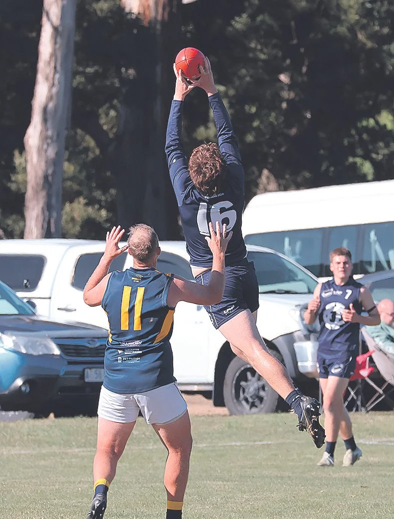 Aaron Mason takes a commanding mark during the match.jpg