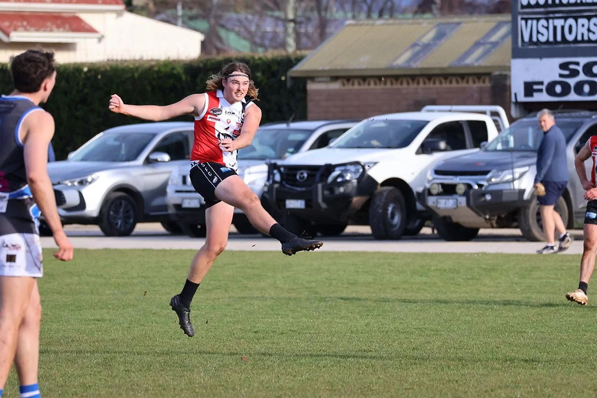 Gworge Davies kicks for goal as Scottsdale dominated Deloraine on a special NEFU celebration day.jpg