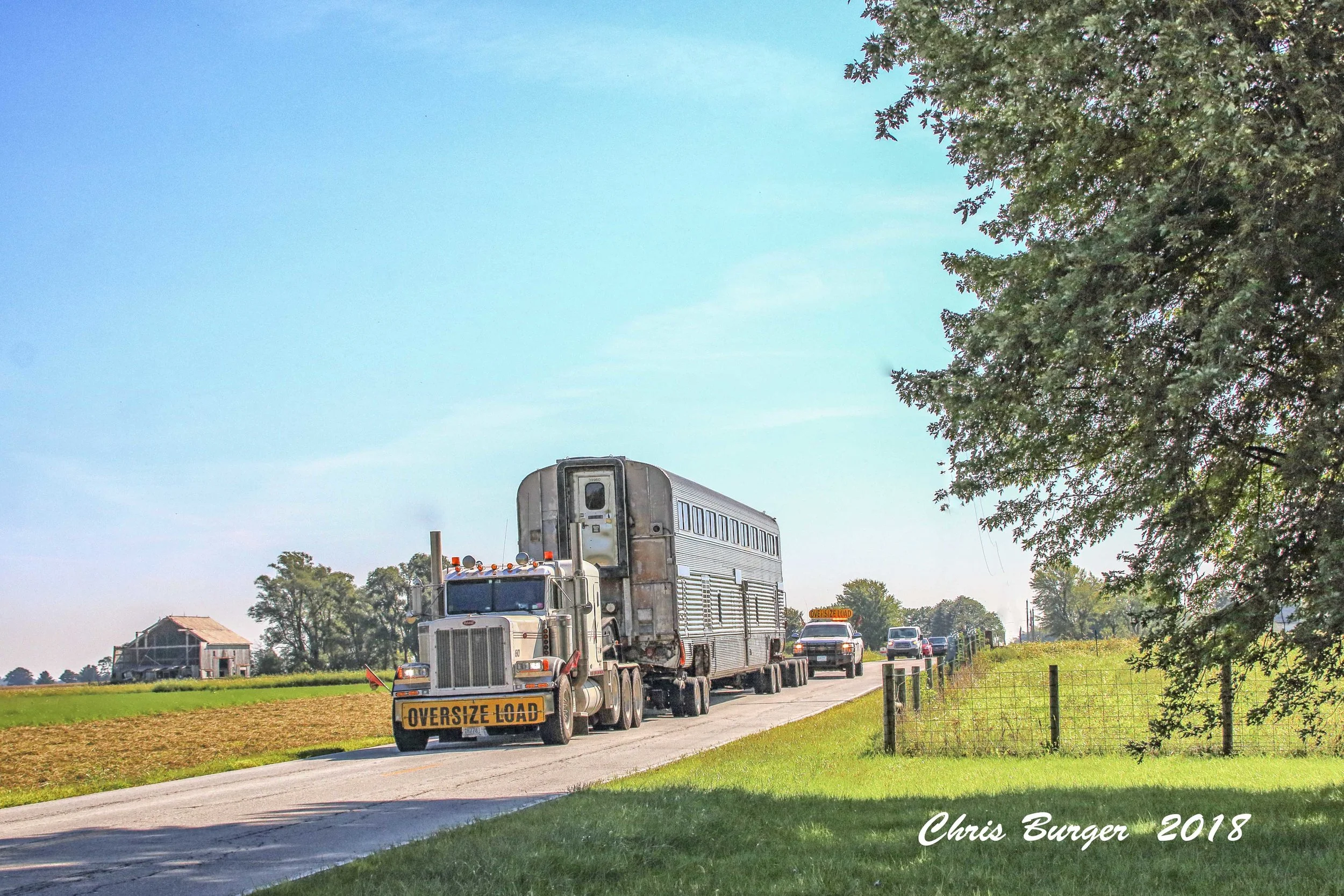 The Nickel Plate Express Santa Fe Cars travel down 266th street.