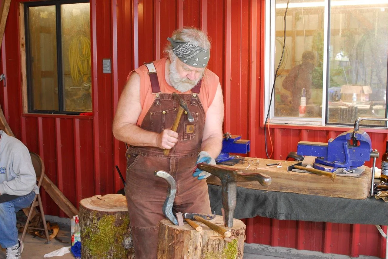 Greg Wilbur works a copper piece.