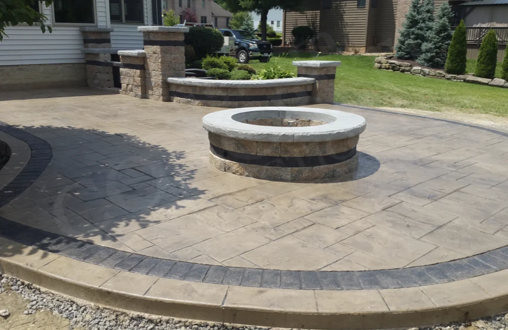 Stamped Patio with Veneer Fire Pit and Outdoor Kitchen completed at a Poland home