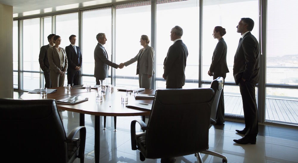 business-people-shaking-hands-in-conference-room-147205360-582f5cdf3df78c6f6a0aef4e.jpg