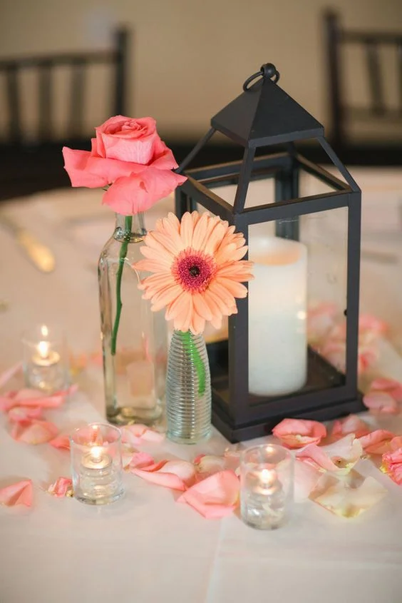 We’re loving this Rustic centrepiece design; lanterns are a huge trend coming from 2018 into 2019. Adding rose petals is a stunning way to incorporate your main colours. https://www.pinterest.ca/pin/473440979555454089/ `