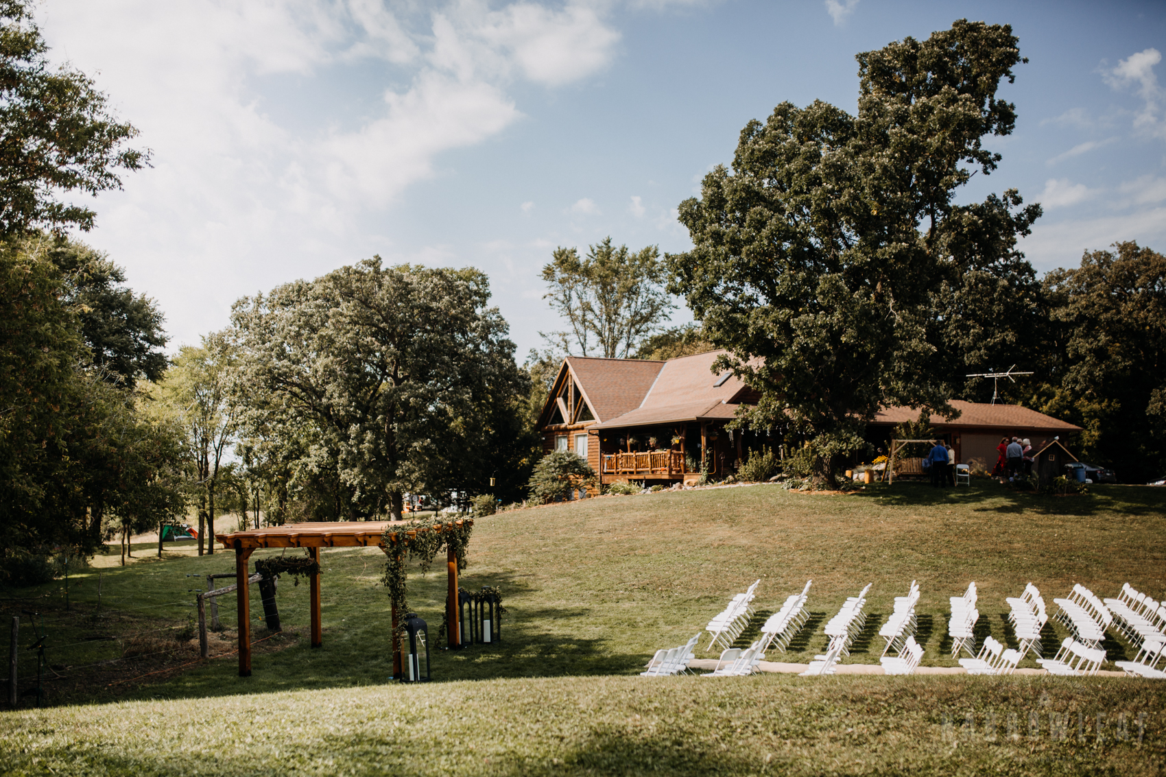 backyard-summer-farm-wedding-greenery-arch-large-lanterns-34.jpg