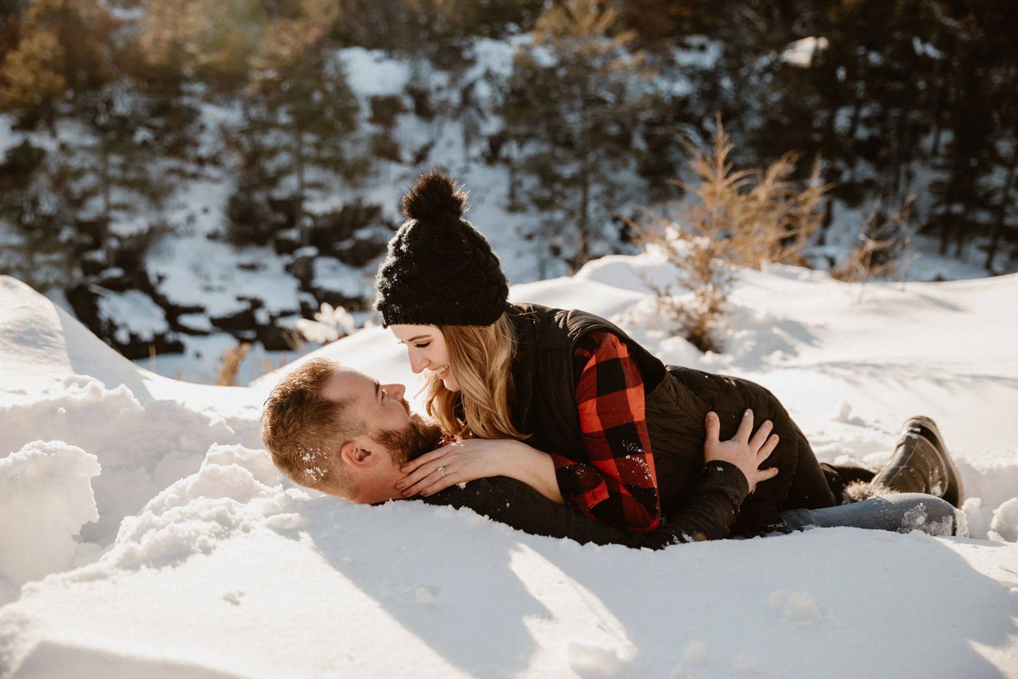 Fun winter engagement photos laying in the snow | Wisconsin elopement wedding photographer