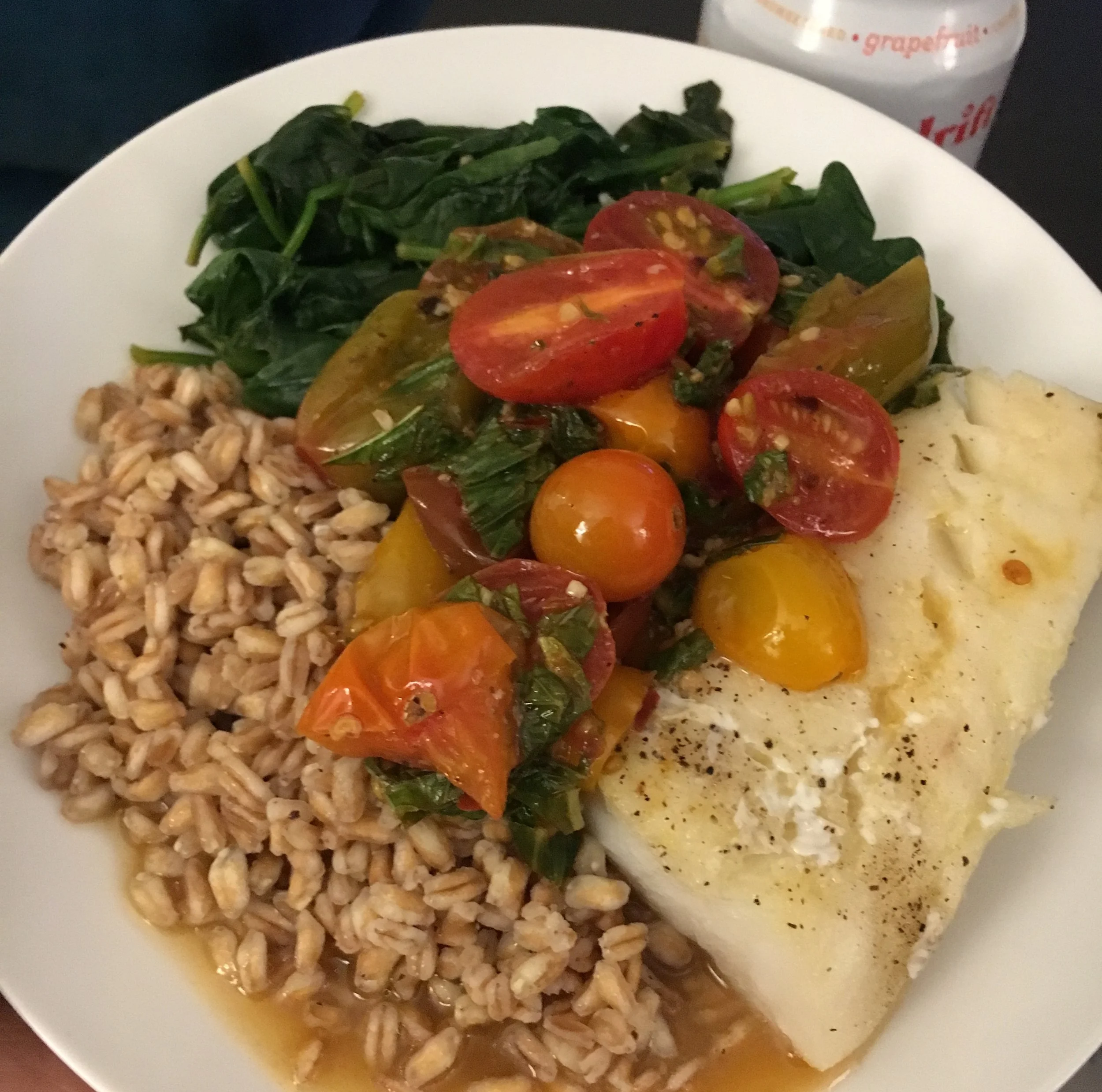 Pacific cod with farro, spinach, and tomato white wine sauce