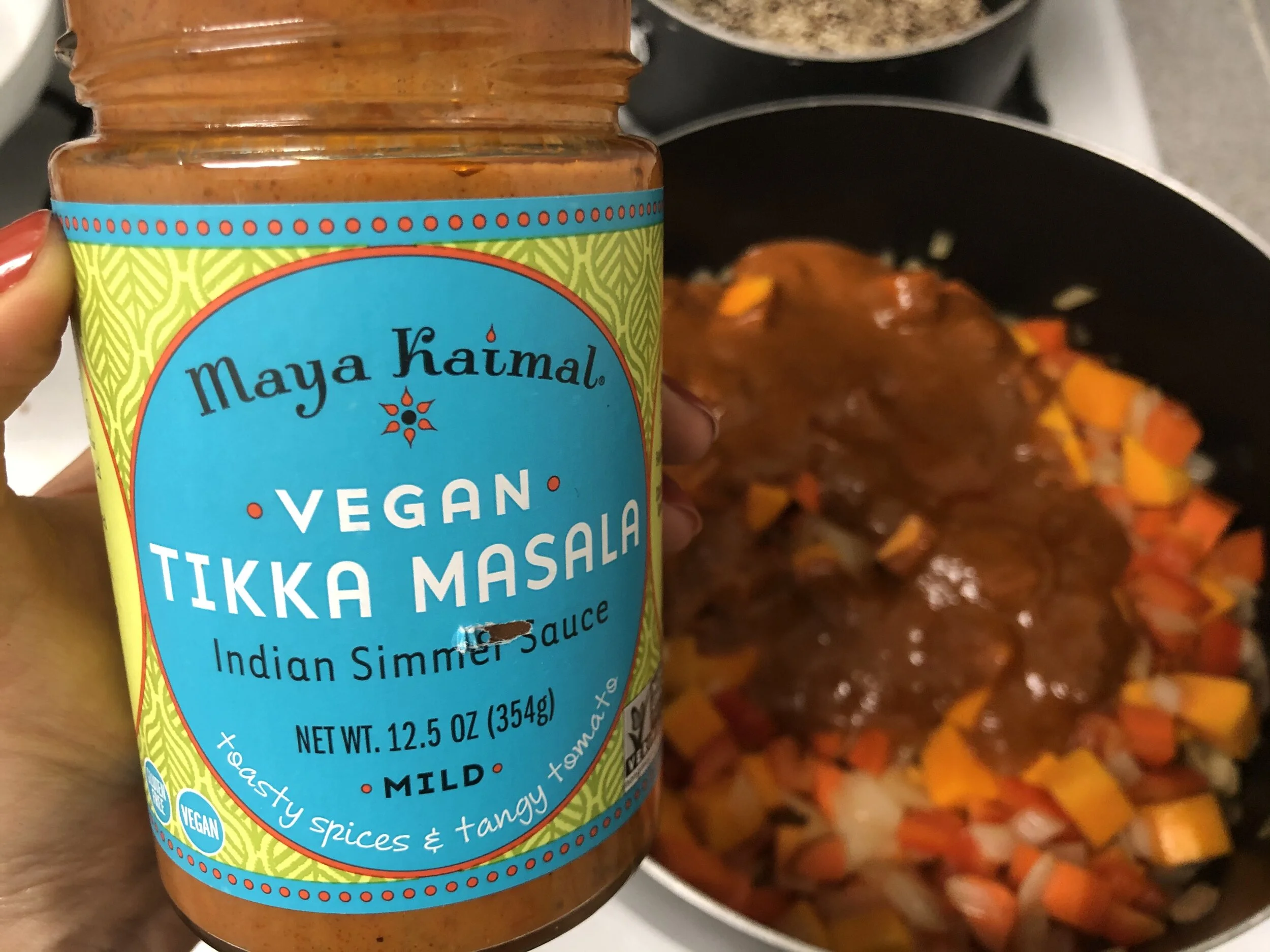 Step 4: The sauce is poured directly into the pan with the vegetables and helps to cook them while adding traditional Indian flavor.