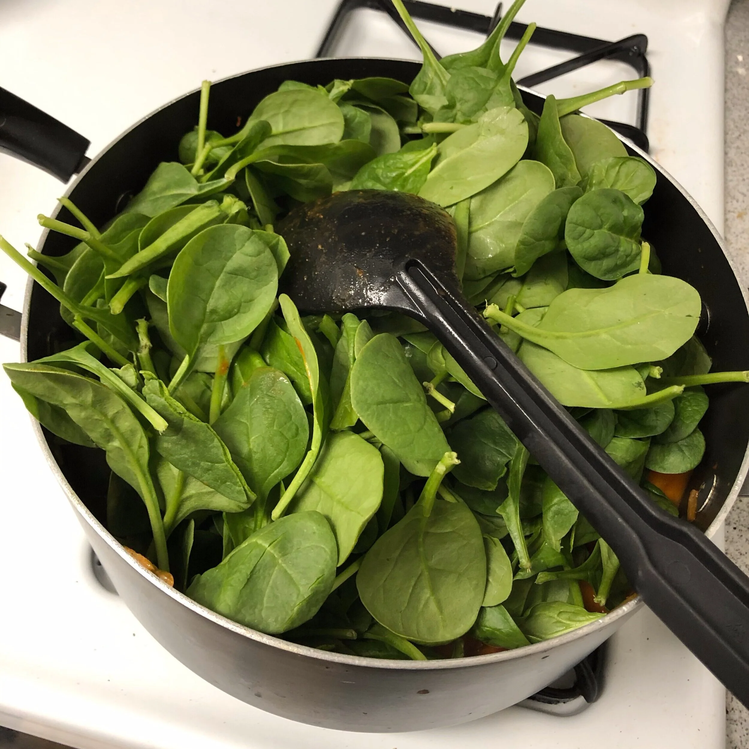 Step 6: The spinach will take up a ton of room at first, but it will cook down within about 5 minutes.