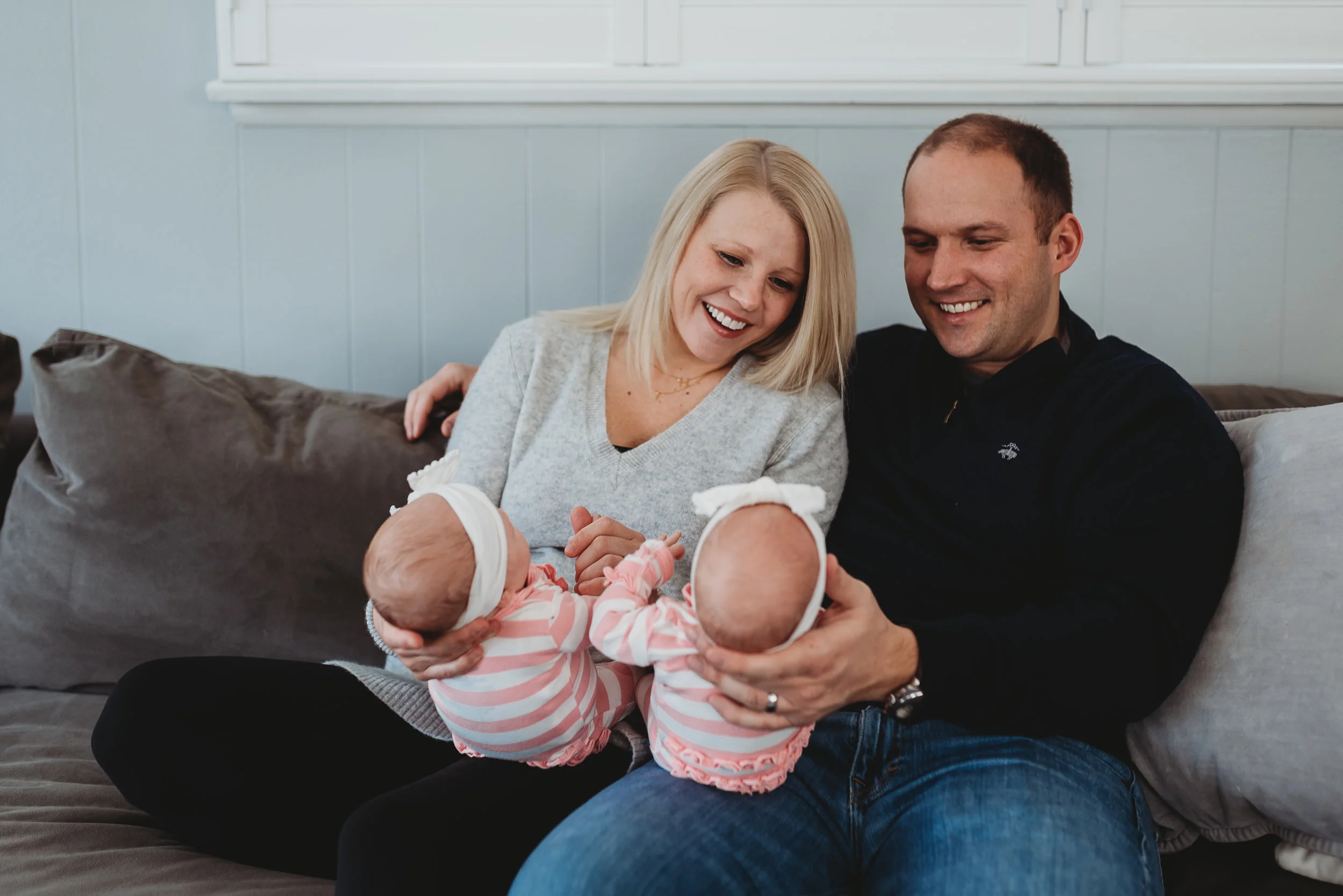 mom and dad smiling at twin babies