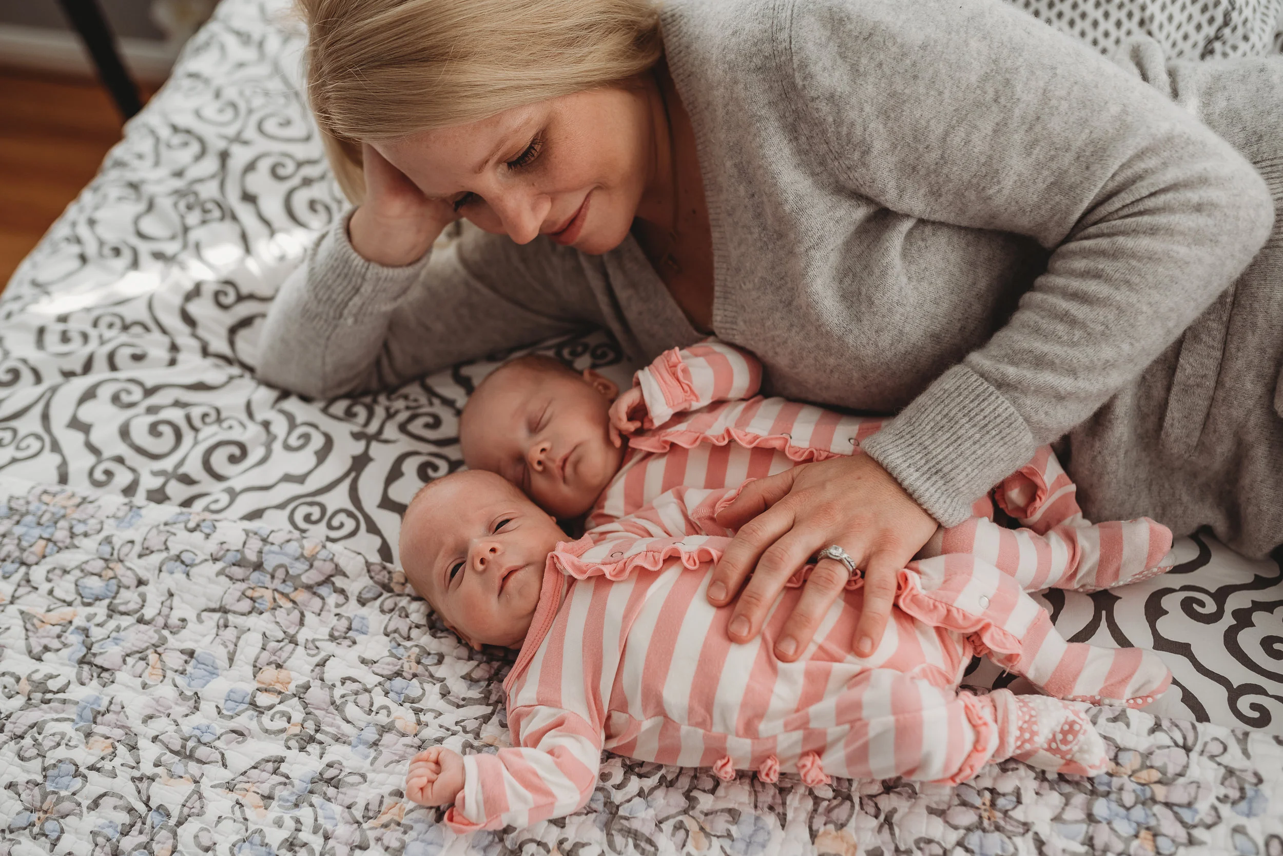 mom snuggling twin girls