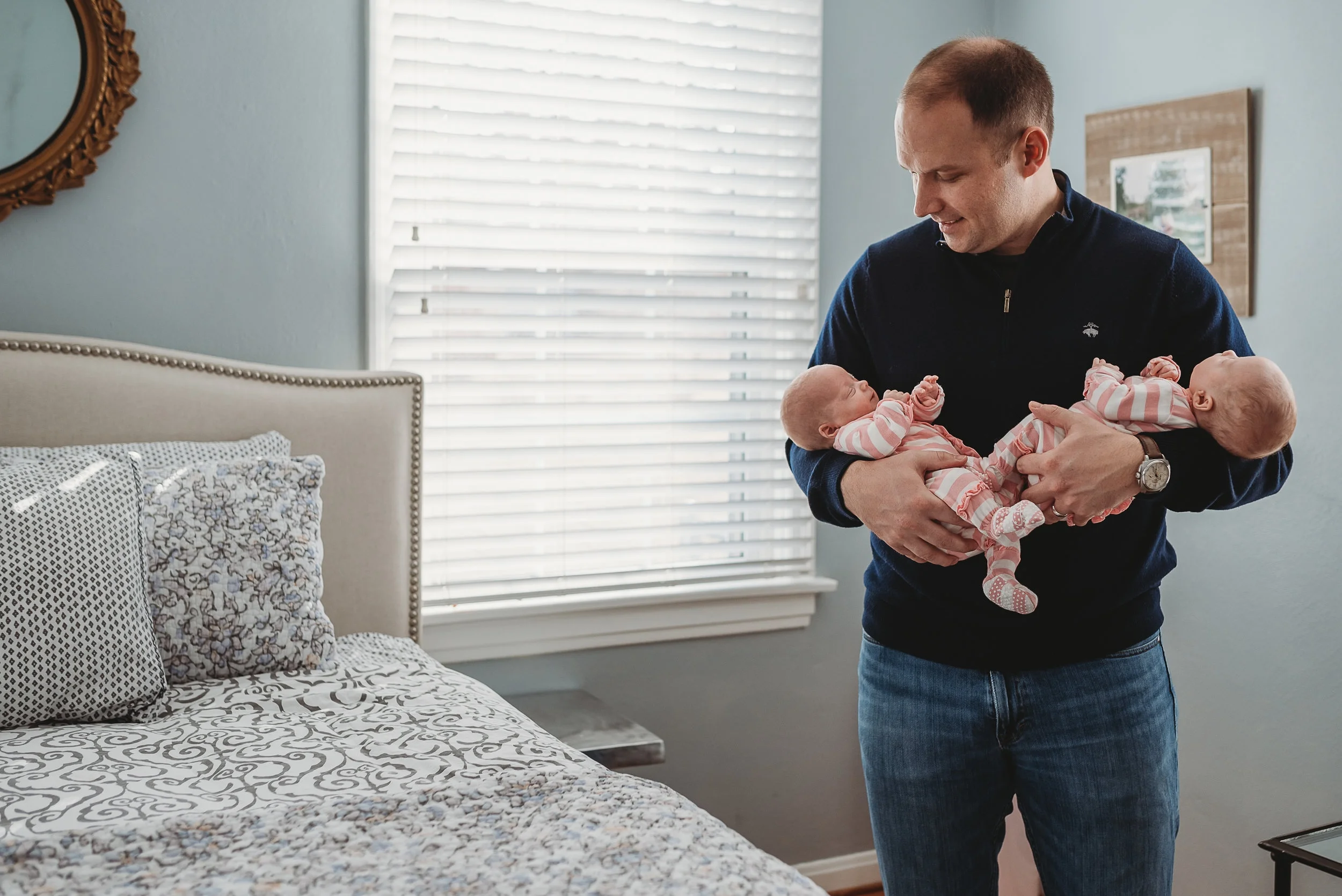 dad holding twin girls