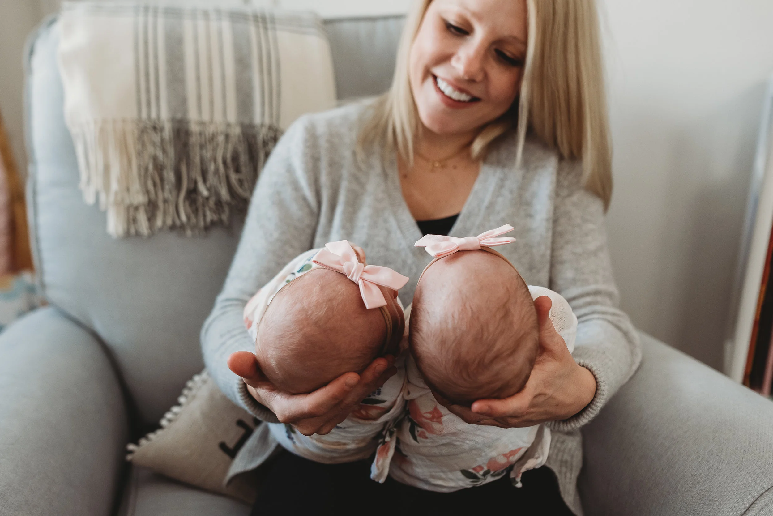 mom holding daughters