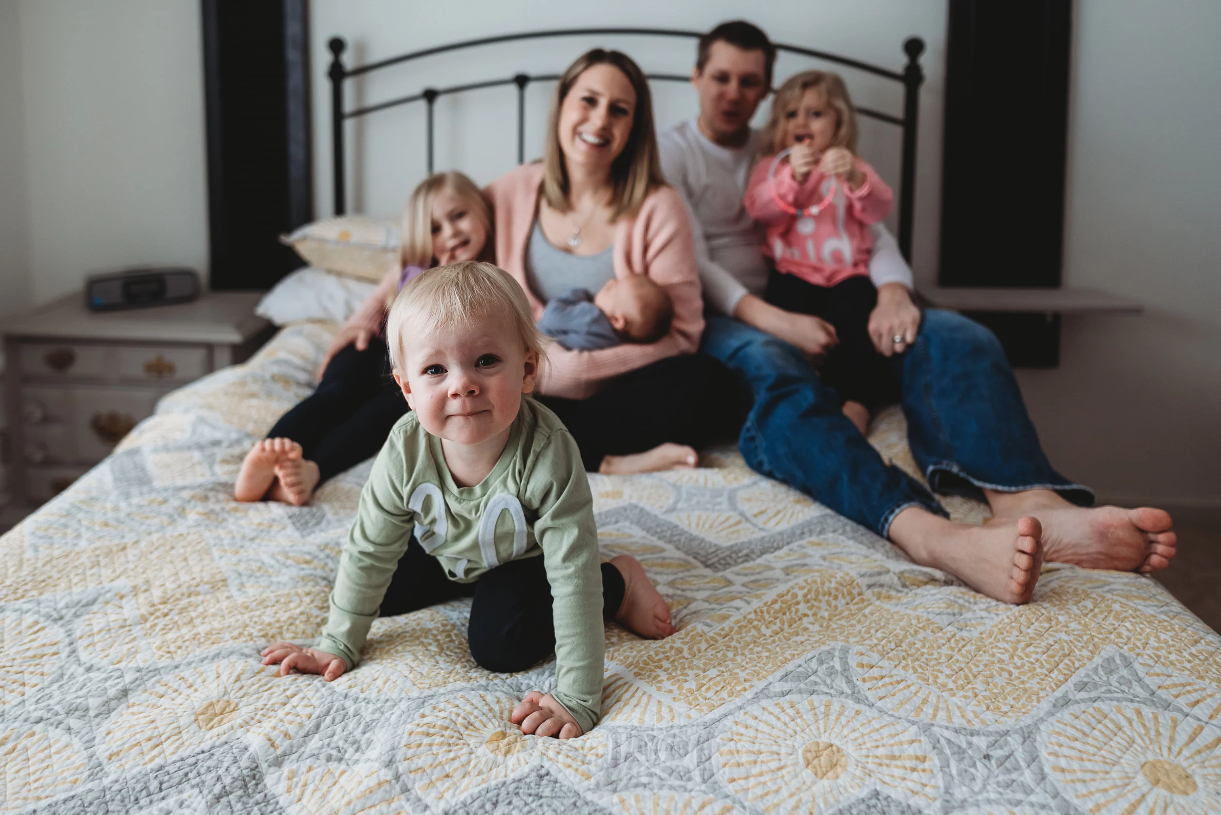 family on bed cuddling