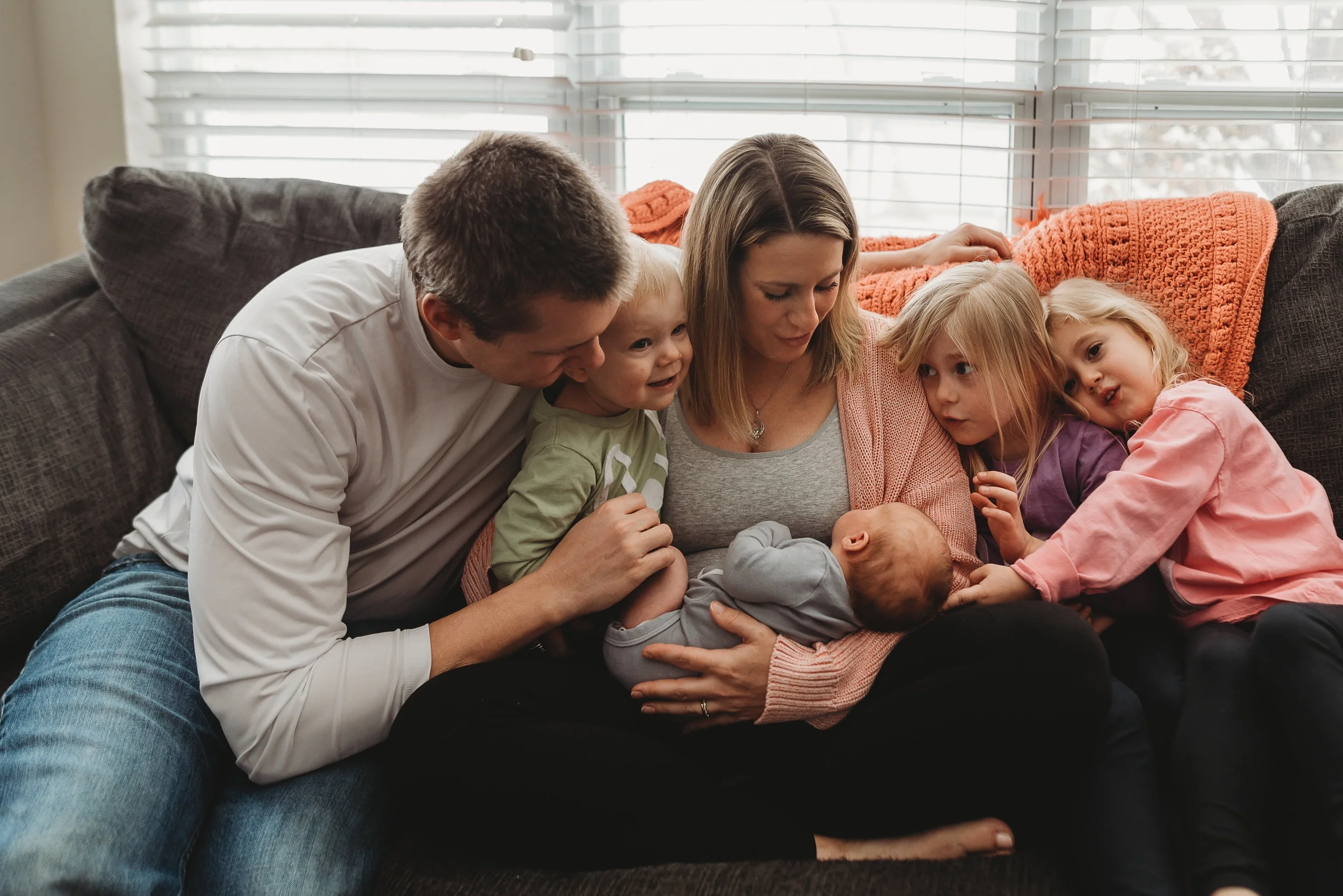 family cuddle on the couch