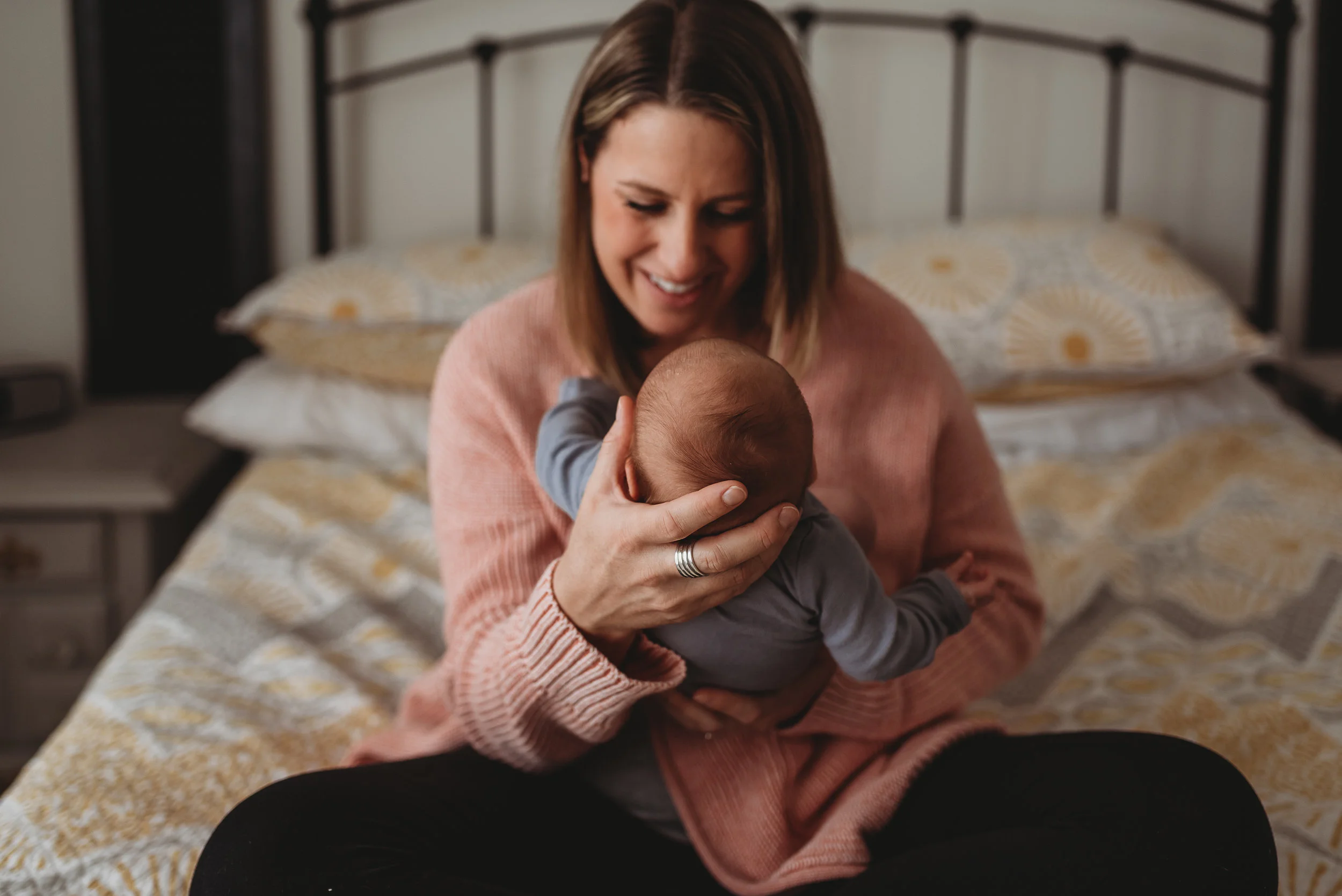 mom smiling at new baby