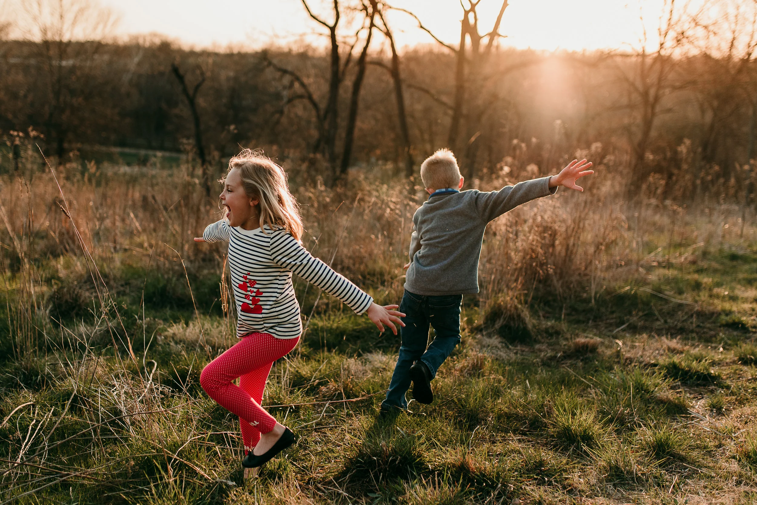 siblings dancing together in sunset light