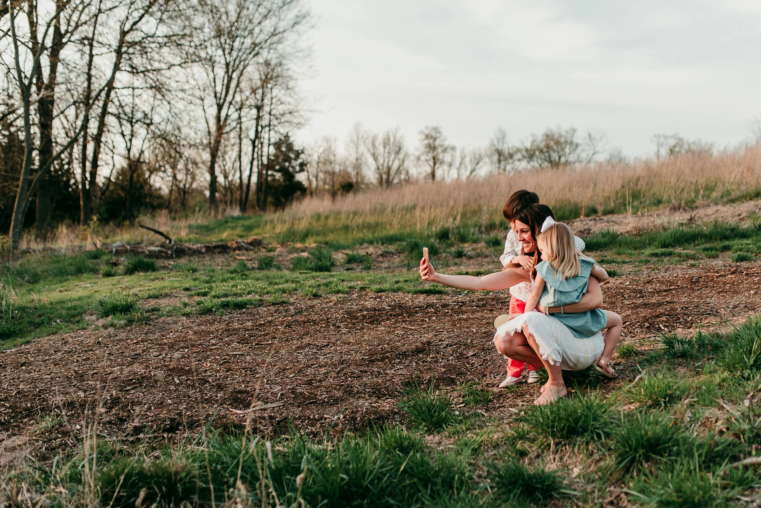 mom talking a selfie with children