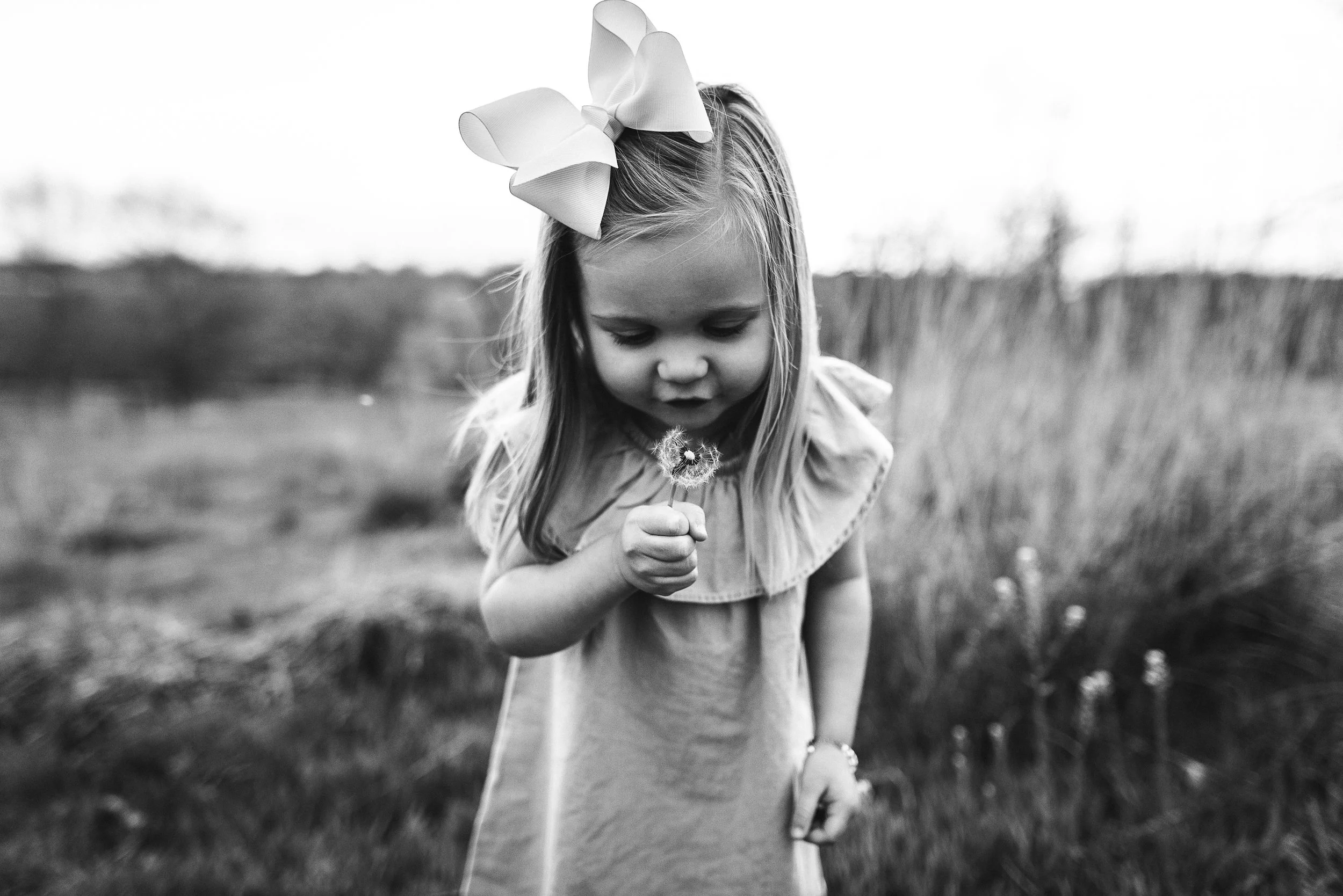 girl blowing flower