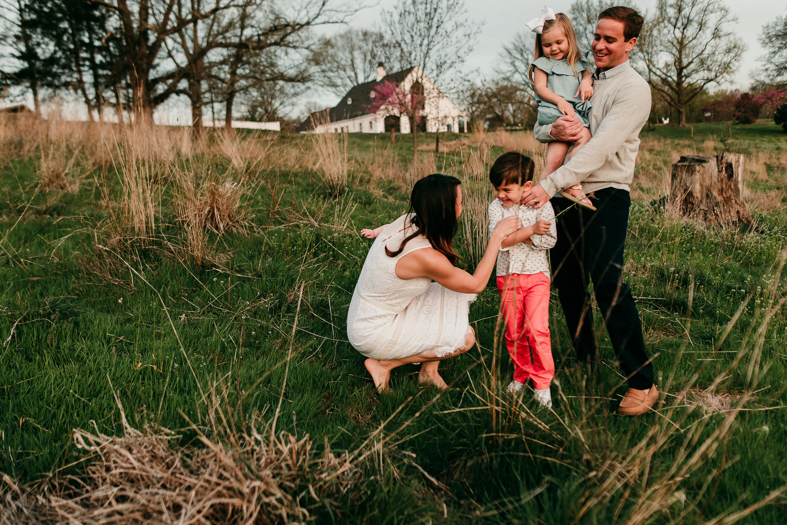 family laughing together in field