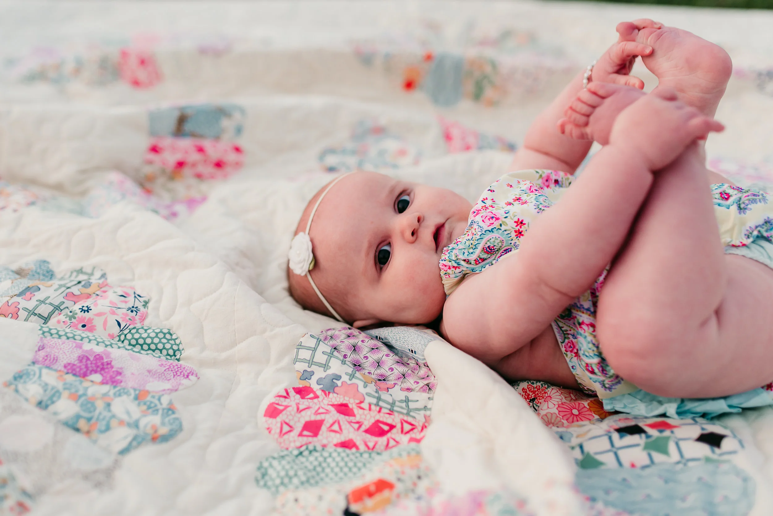 baby holding her feet St. Louis baby photographer