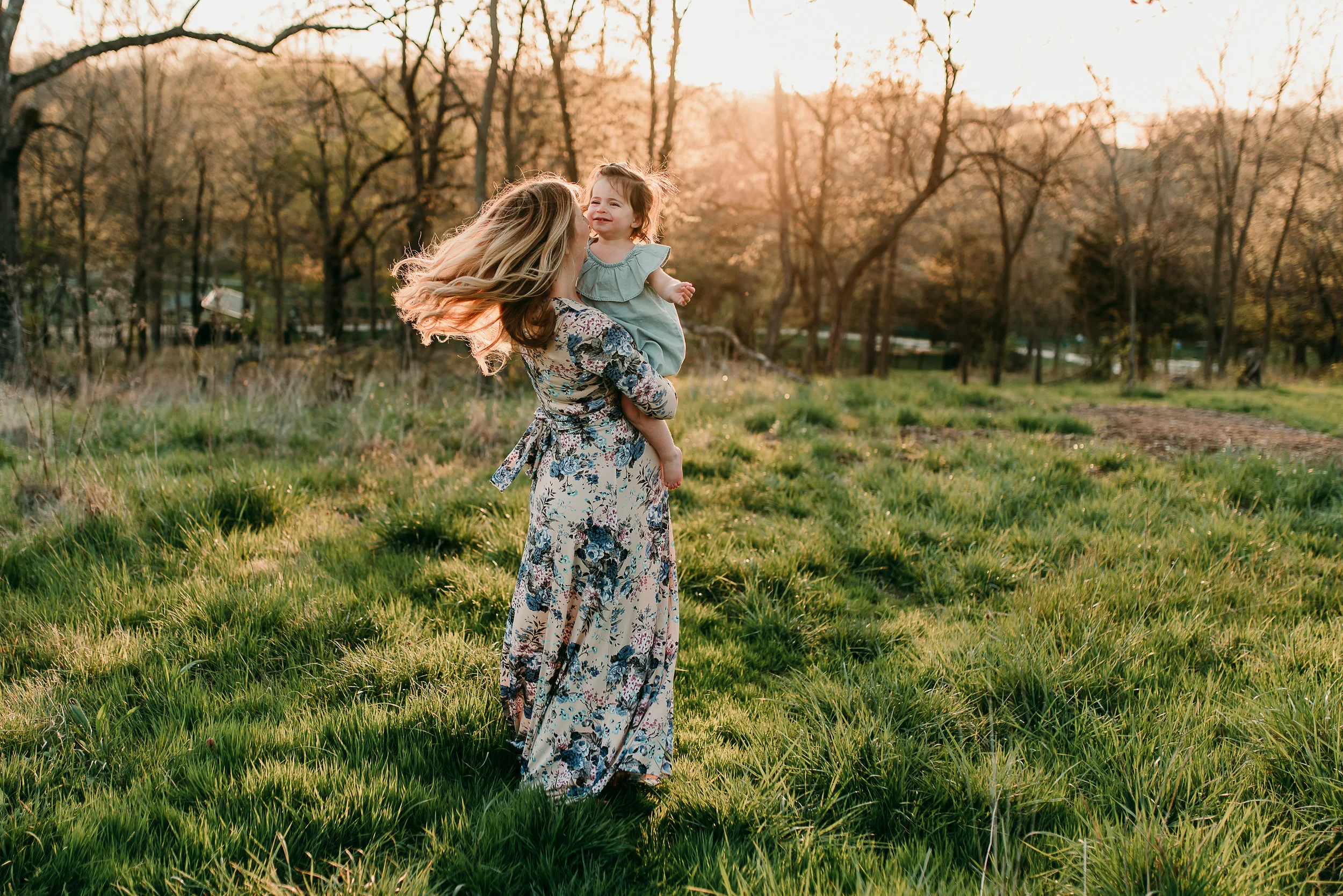mom spinning together in field