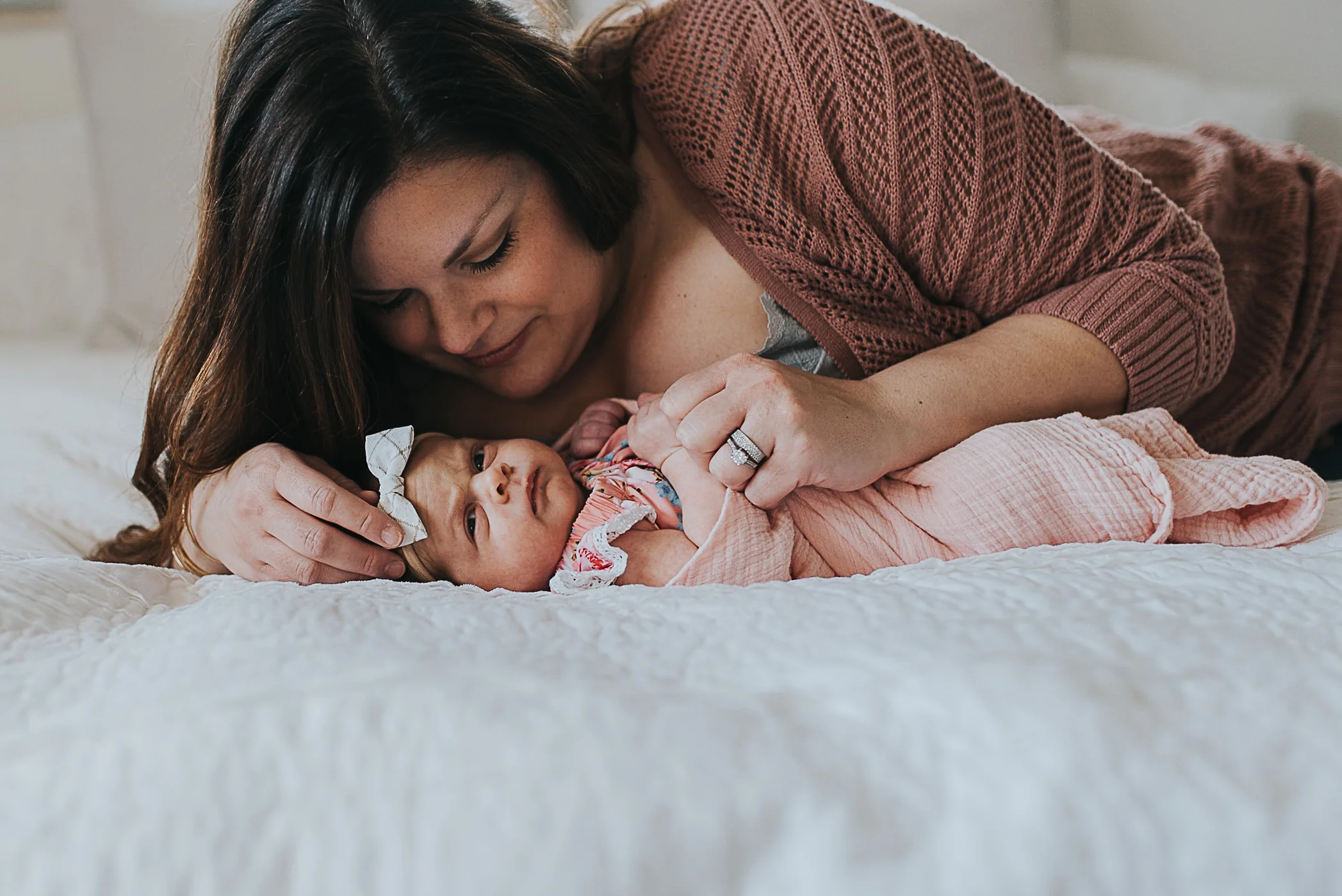 mom laying bed with baby