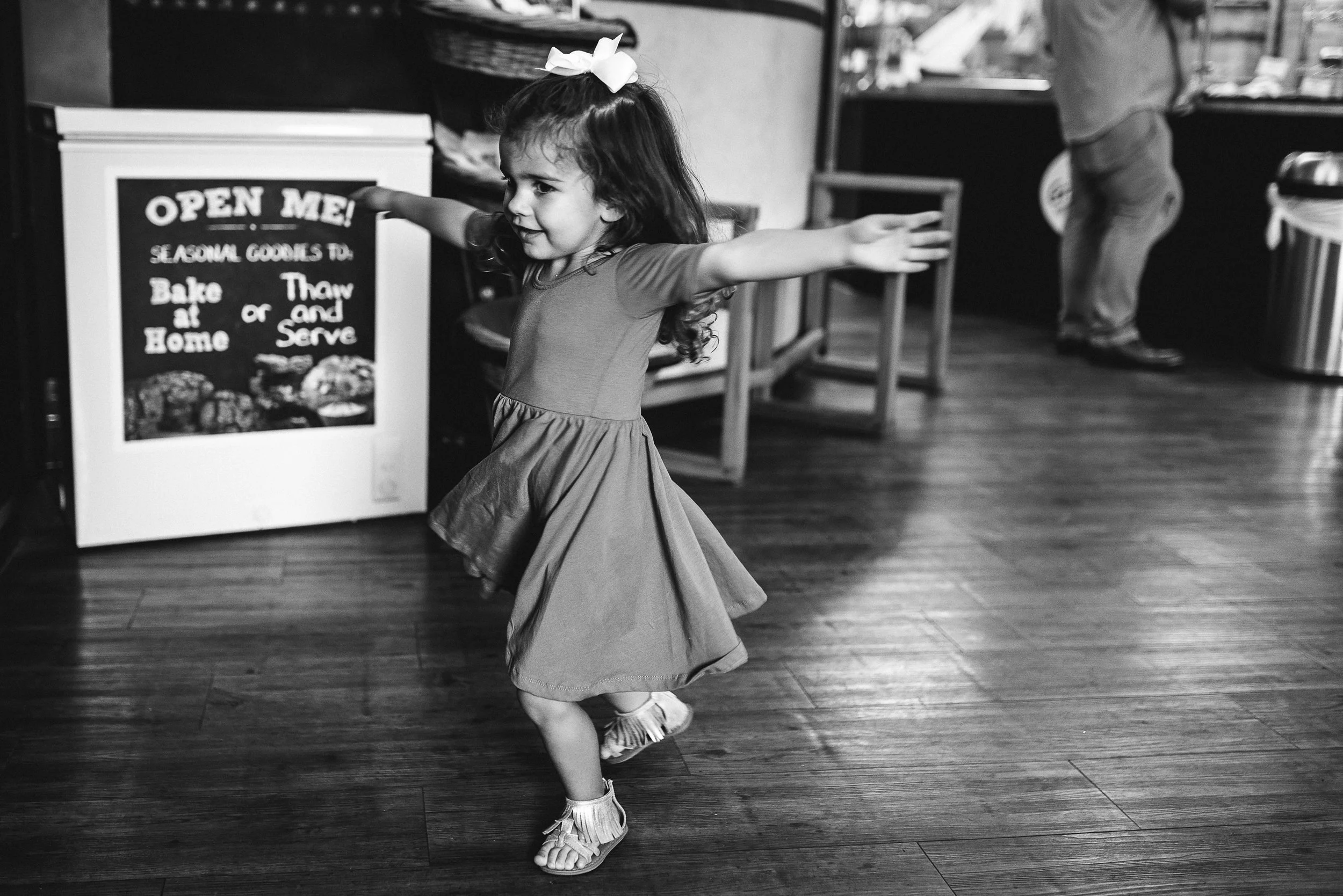 daughter twirling in bakery