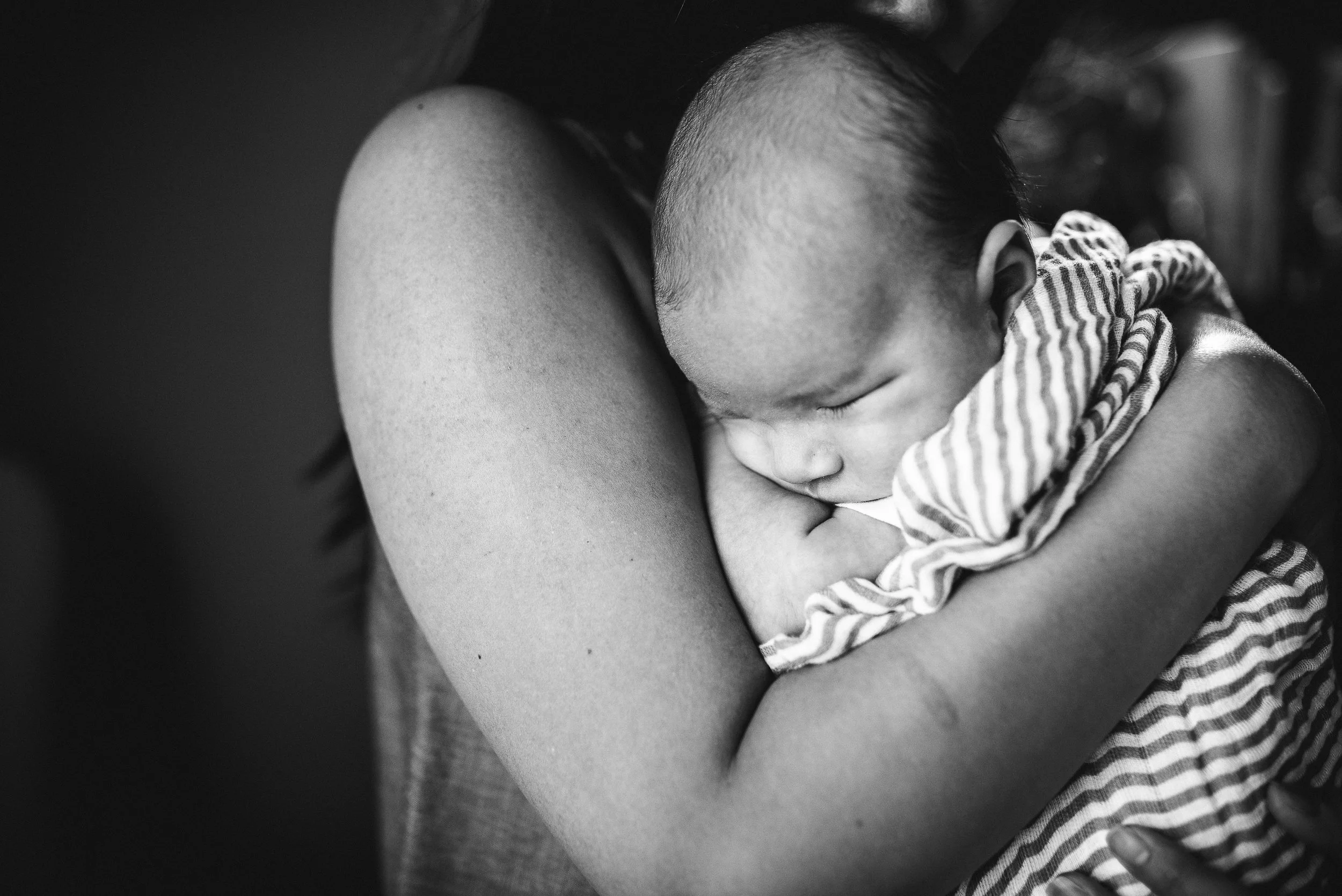 baby boy snuggled into mom's arms