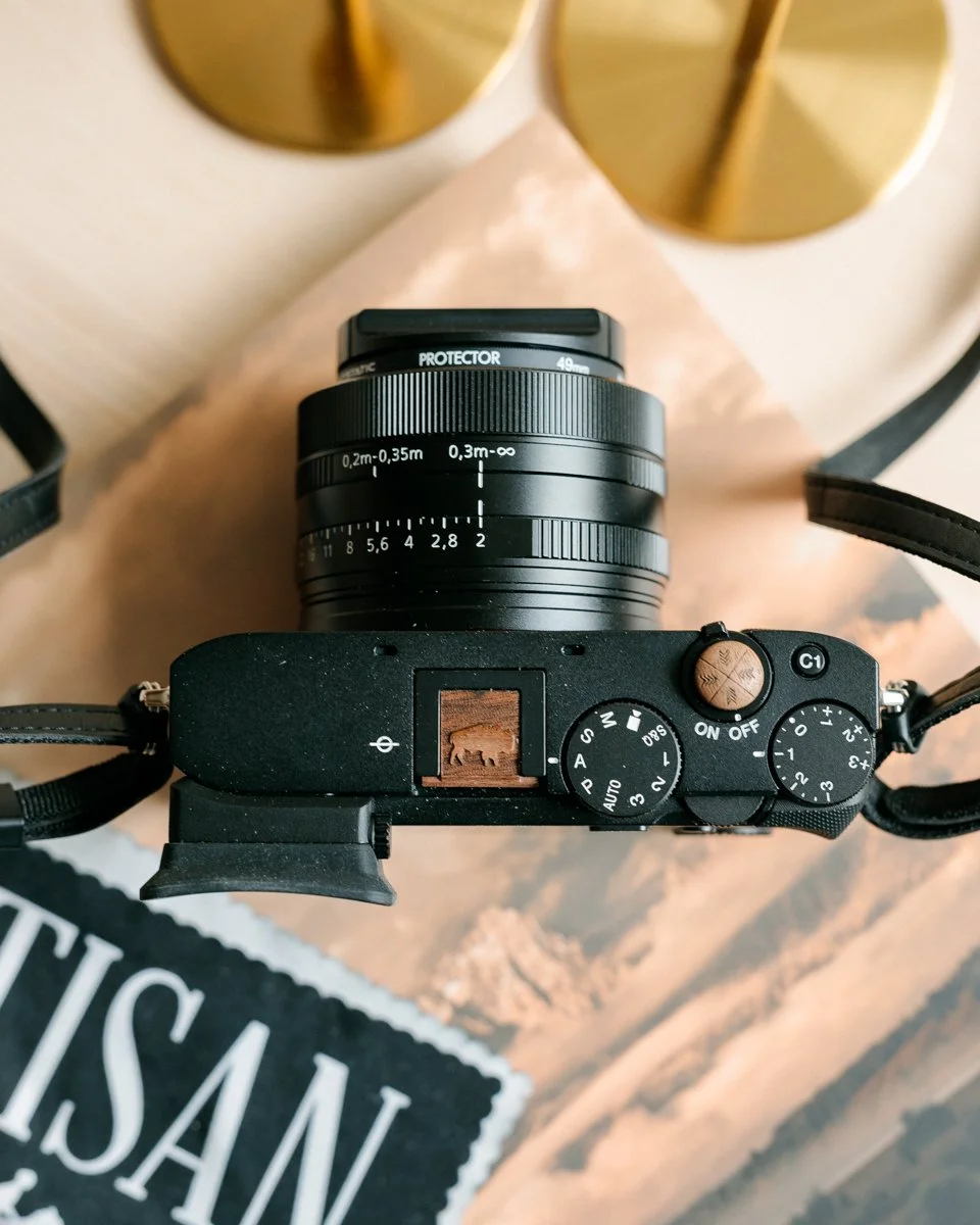 &ldquo;There is something about a photograph that stops time. You hold a moment forever.&rdquo; - Annie Leibovitz

This Sony RX1RIII is outfitted for the story: a Bison-engraved hot shoe cover and Arrows soft release button, handcrafted to remind you