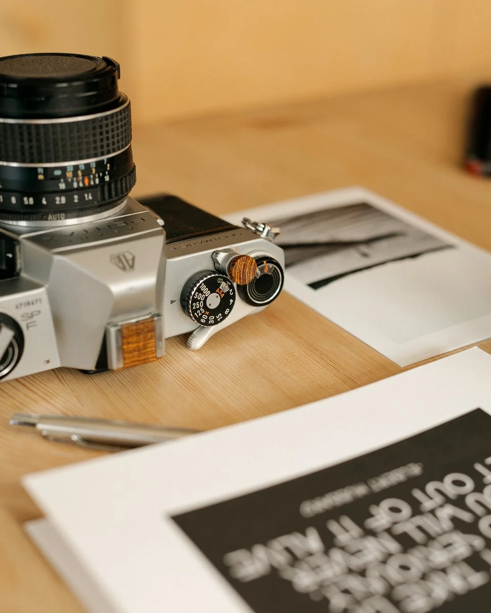 &ldquo;The negative is the equivalent of the composer&rsquo;s score, and the print the performance.&rdquo; &mdash; Ansel Adams

A camera on the table.
Fresh prints beside it.
Light coming in softly from the side.

This is where photography becomes re