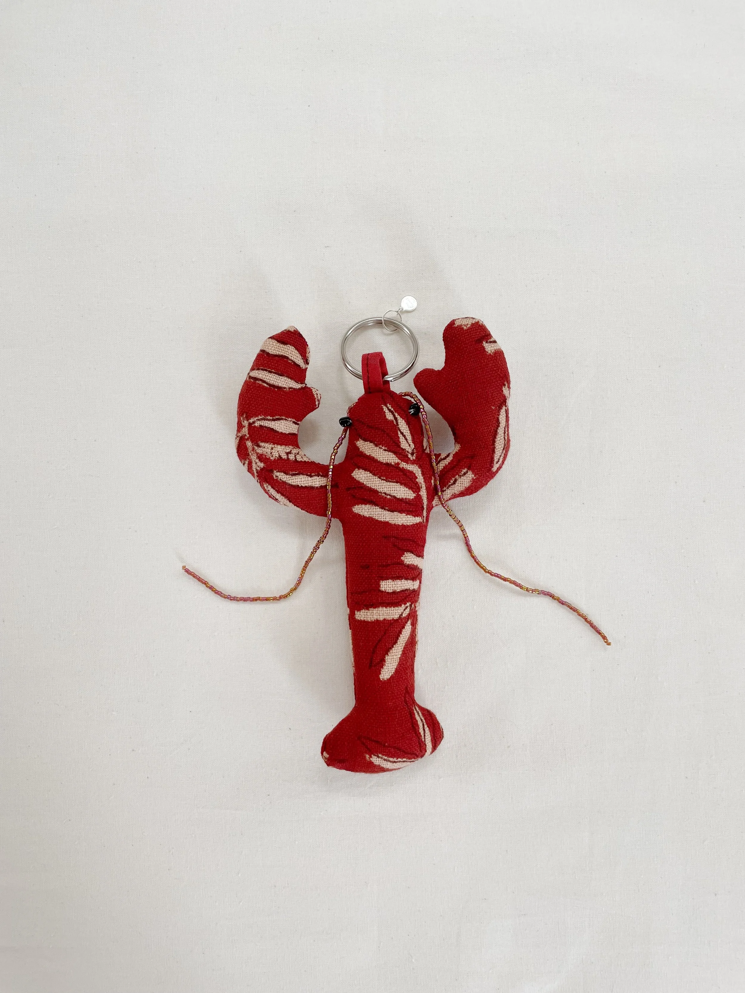 Lobsters keychains — to The Sun by Debbie IChing Sun