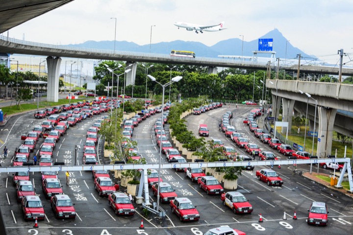 The main taxi queue at Hong Kong's world class Chek Lap Kok Airport on Lantau Island. Red cabs to Hong Kong Island and Kowloon, Green cabs to the New Territories and Blue cabs to destinations on Lantau. When time is of the essence, I often take clients directly to Victoria Peak in a red cab.