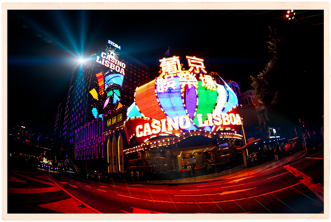 CASINO LISBOA (All Rights Reserved, WilliamBanzai7, 2016) Everyone who meets me quickly learns that I love Old Macau! I love Portugal as well and have been there many times. Perhaps that is why I can say Macau is like a Lisbon on the South China Coast. The old city of Central Macau is a treasure trove of lovely old mosaic streets, quiet public sitting areas, old fortresses, gritty old Chinese temples, incensed street shrines and majestic cathedrals, lush parks teeming with Cantonese style street activity and some very old and relatively undisturbed Chinese neighborhoods with very old houses (think time warp). Naturally, it is full of history. That history and uniquely mixed Macanese culture spans the period from the mid-1500s to date. It is my view that Macau and Hong Kong go hand in hand and that in order to get a complete picture of the history of the Pearl River Delta, one should try to visit both cities as well as Old Canton (Guangzhou), if possible. Remember, when the British landed in the area, they got started in Macau. The Americans as well. Would it surprise you to learn that many of the gravestones in the old Protestant graveyard mark the remains of young seamen from New England? Think Yankee Clippers. Although I go to Macau all the time (my wife has family there), I am not a gamber, and as a general matter, I have no interest in entering the casinos. Why go to the Venetian when you have been to Venice? All the big players from Las Vegas have done a fine job of replicating the Las Vegas strip in an isolated area that like much of modern Macau and Hong Kong, began as landfill. Thankfully it is no where near the center where I love to wander, photograph the street life and bring fellow visitors. There is, however, one casino I love to shoot from many angles. The Casino Lisboa founded by Stanley Ho, also known as the "King of Gambling". Here again is a connection to Hong Kong. Stanley Ho is a grand nephew of Sir Robert Ho Tung , the famous Hong Kong businessman and philanthropist whom I cover on my Hong Kong walking tours to Victoria Peak. As you can see above, there is plenty of neon at the old Lisboa. It has the look of old school Las Vegas and there is always a pack of gaunt bicycle rickshaw men lined up in front. If anyone asks to see a seedy old Macau casino, this is my go to destination. And if anyone asks where to find the saunas, I send them to those rickshaw men. After Stanley Ho lost the casino monopoly in Macau and Vegas players like Steve Wynn and Sheldon Adelson entered the local scene, he went and built a spectacular casino hotel just across the street, The Grand Lisboa. It is shaped like a giant mirrored lotus flower, which figures in the official emblem and flag of Macau as well. By the way, the peninsula that became old Macau was originally shaped like a lotus bud. The building can be seen from points all around the center and thankfully, although imposing, it is an interesting work of modernist architecture. Evening time, the area surrounding the hotel is drenched in neon emanating from various commercial establishments, including a multitude of nearby pawn shops eagerly awaiting your Rolex watch. How else does one finance one's losses at the tables? I regularly do day tours to Old Macau. To view more of my images of Macau, please visit my Flickr Stream or visit me on Instagram: @williambanzai7 . Hope to see you soon on the Streets of Hong Kong or Macau! WB7 End of Dispatch